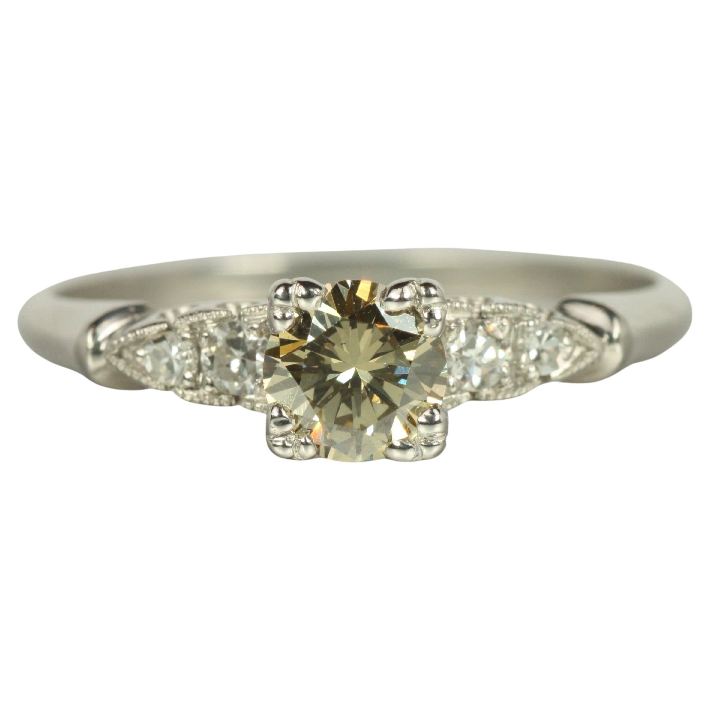 1950s Platinum Engagement Ring – 0.54ct Fancy Yellow Diamond & 0.12cttw Sides