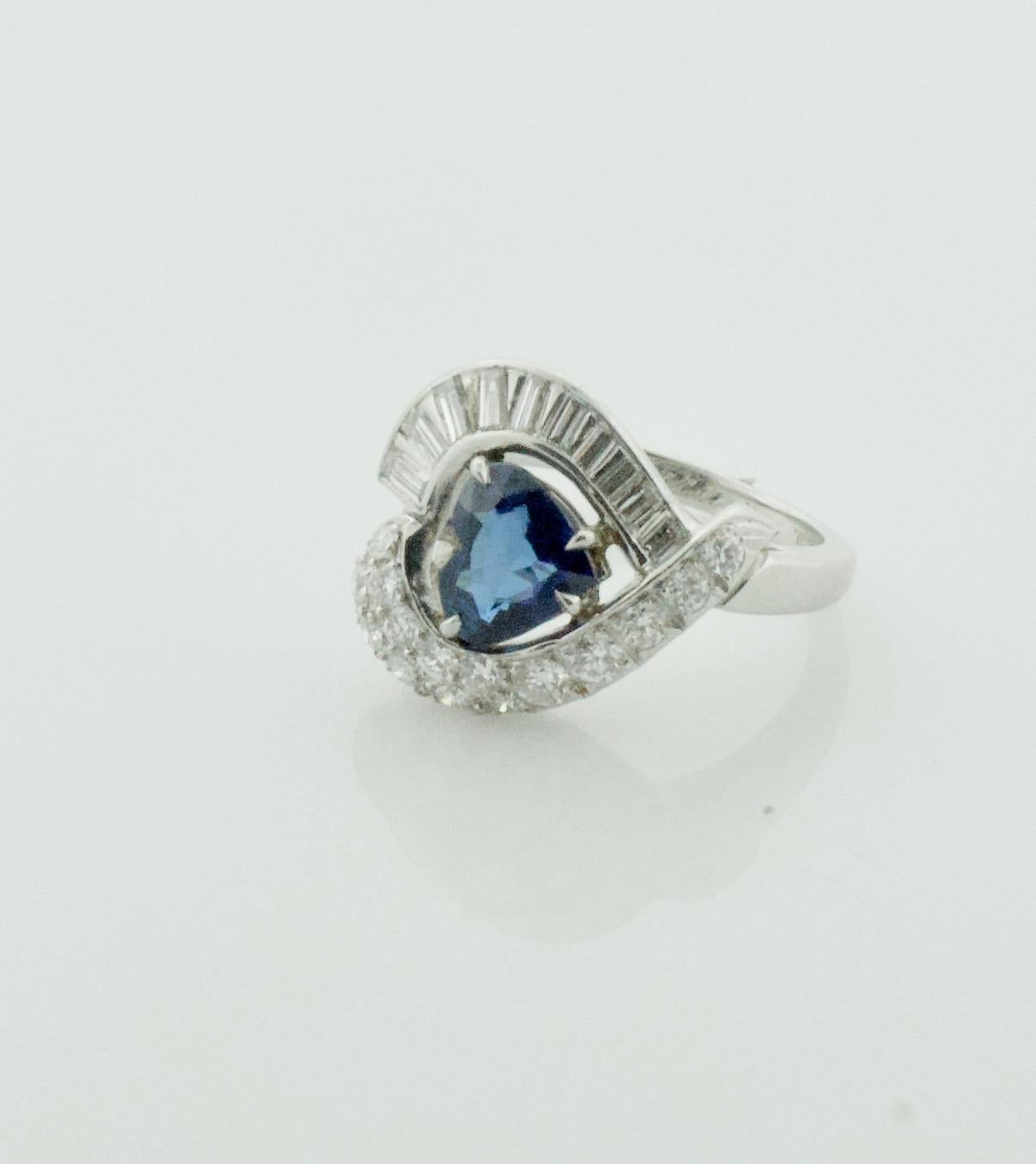 1950's Platinum Heart Shaped Sapphire and Diamond Ring
The Heart Wants What The Heart Wants. And This Heart Wants To Face East-West
One Heart Shaped Sapphire Weighing 1.65 Carats Approximately [bright with no imperfections visible to the naked