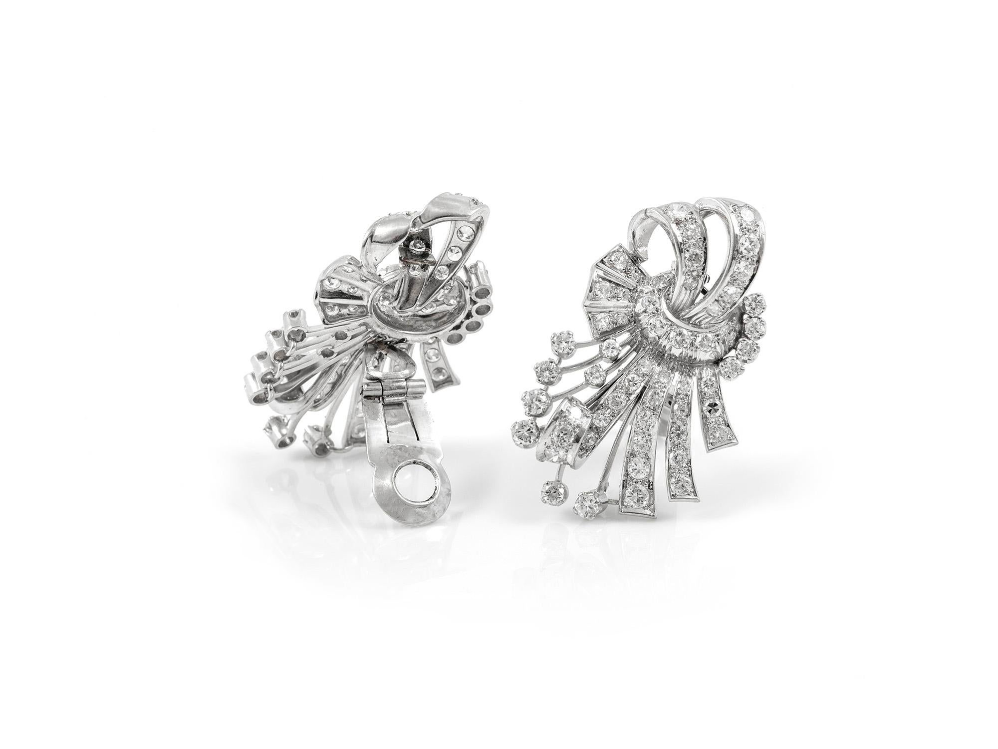 The earrings are finely crafted in platinum with diamonds weighing approximately total of 6.00 carat.