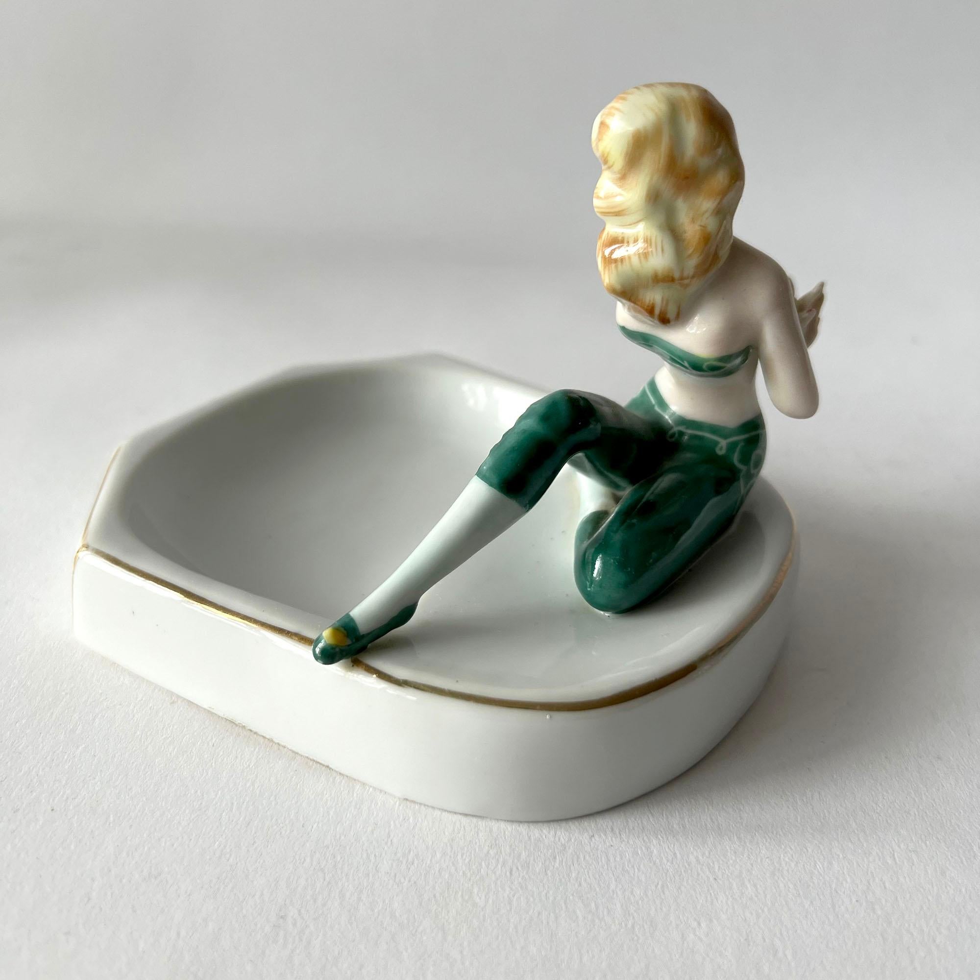 Risqué porcelain pin up girl ashtray or vide-poche, circa 1950's. Piece measures 3.75