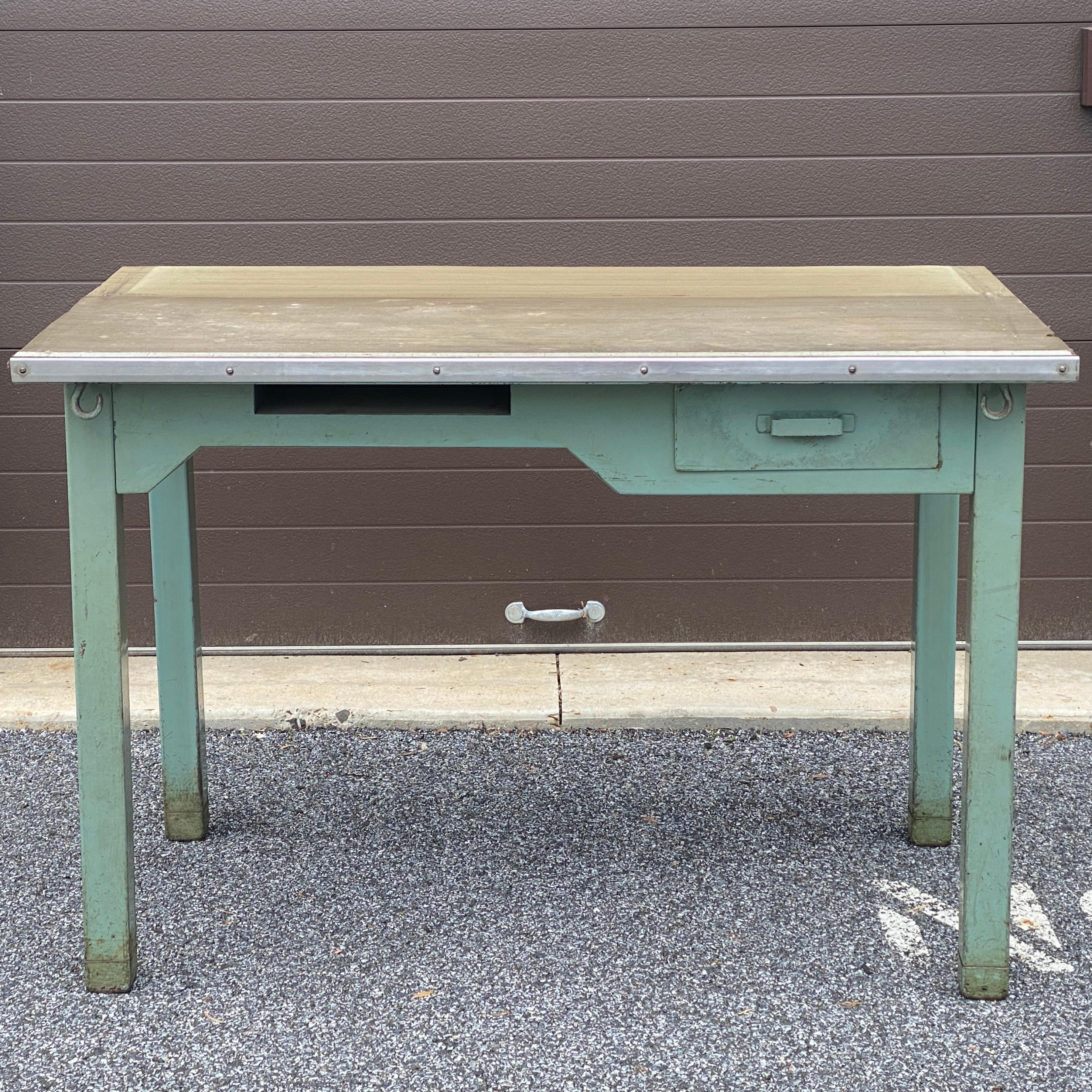 Vintage industrial salvage USPS Post Office steel mail sorting station desk circa 1956 with single drawer, cubby, and various hooks underneath. 
Knee clearance variable
27.5” on left side 
25.25” under drawer