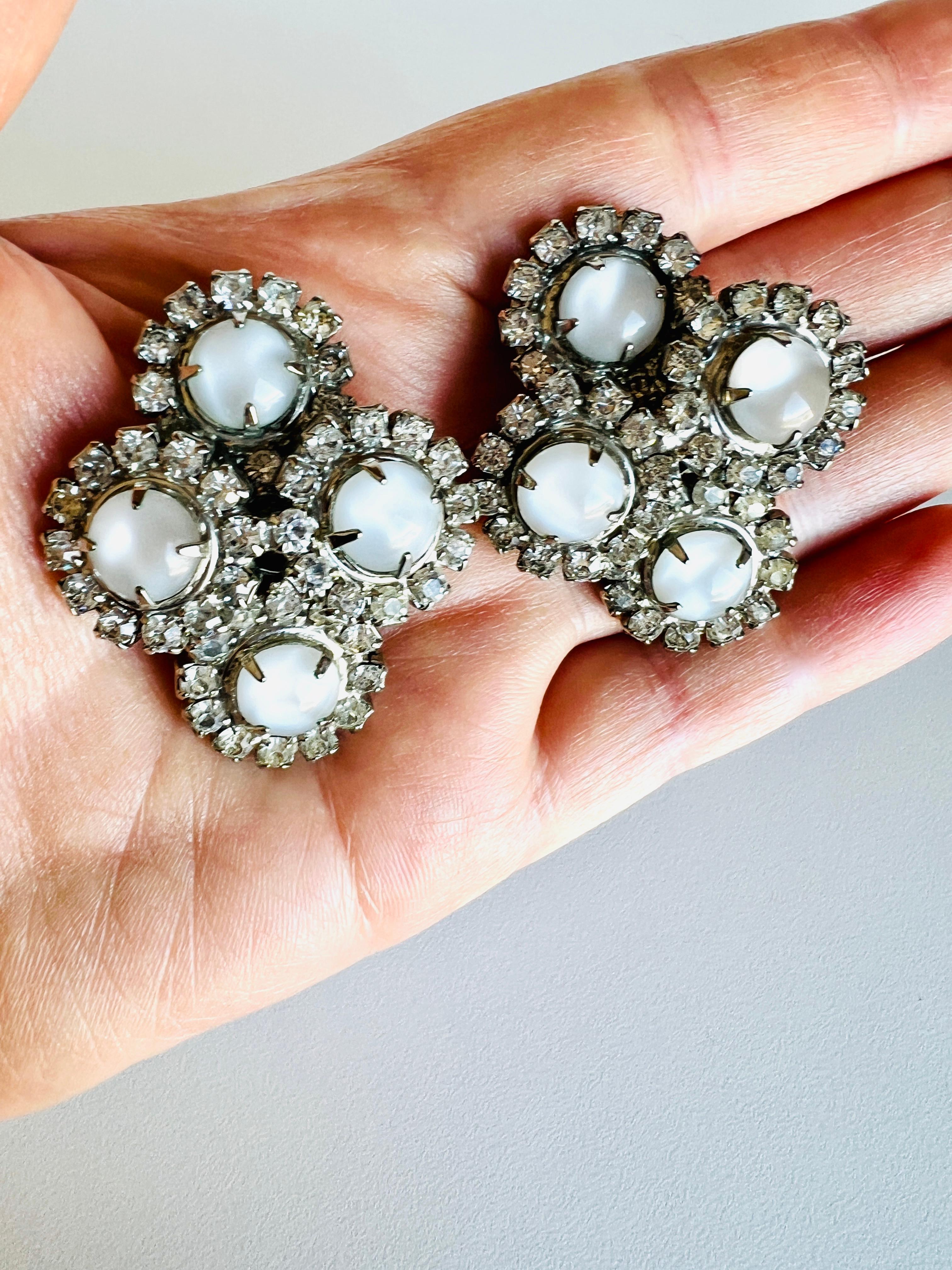 These lovely vintage earrings are well-constructed and quite large. They feature prong-set rhinestones and imitation moonstone glass cabochons set in silver plated metal. 

Size:  1-5/8