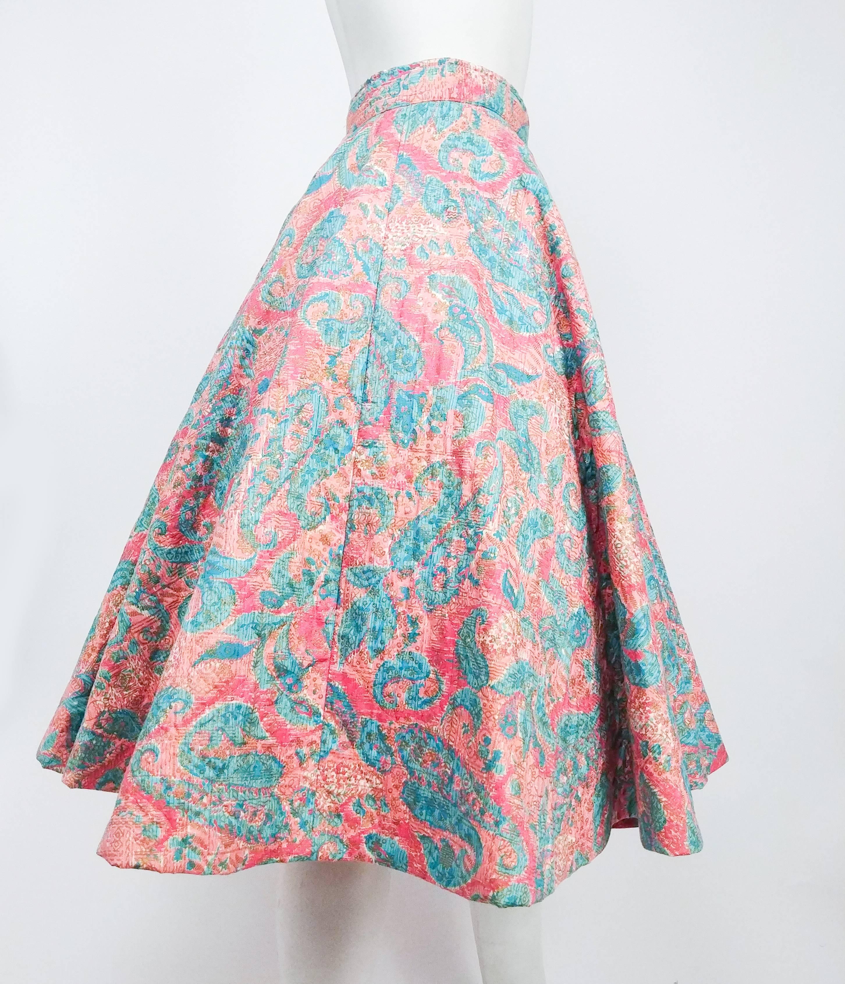 1950s Quilted Cotton Print Circle Skirt. Blue and pink printed cotton fabric with gold painted overlay. Thick, supported feel due to quilting. Button and zipper closure at side. Skirt is shot on petticoat in photo. 
