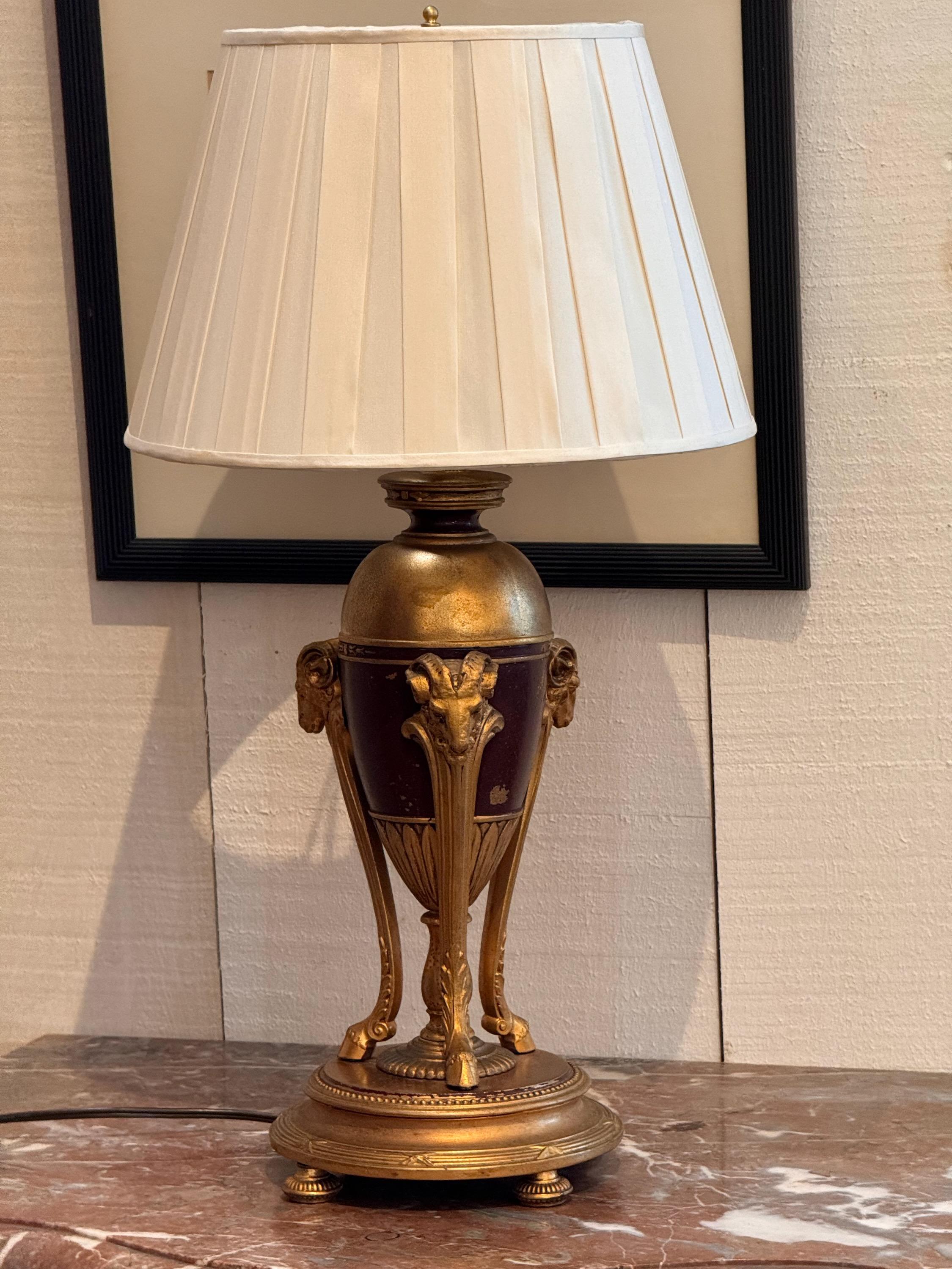 A neoclassical style lamp. Painted metal and bronze.