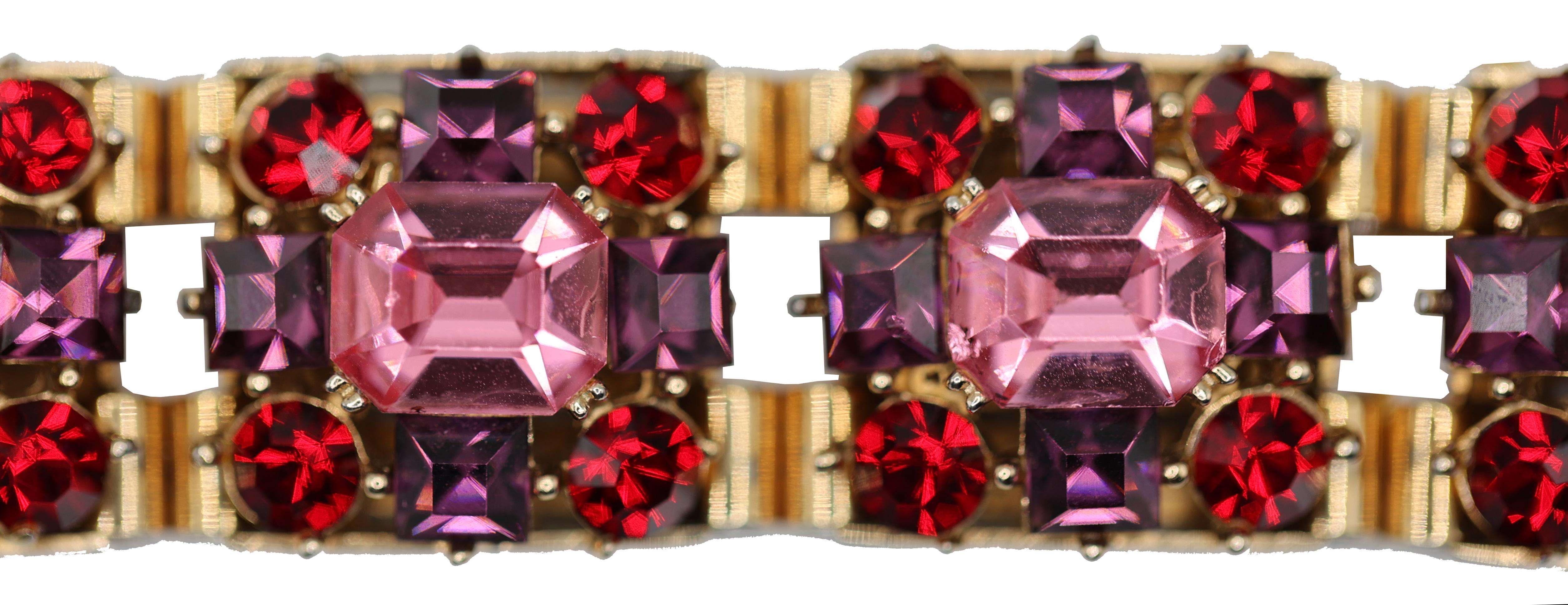 1950's Rare Austrian Crystal Collectible Bracelet

This stunning Austrian Crystal bracelet features 7 large deep pink emerald cut crystals surrounded each by 4 round ruby red crystals and 4 square cut amethyst color crystals. The 7 gold color links