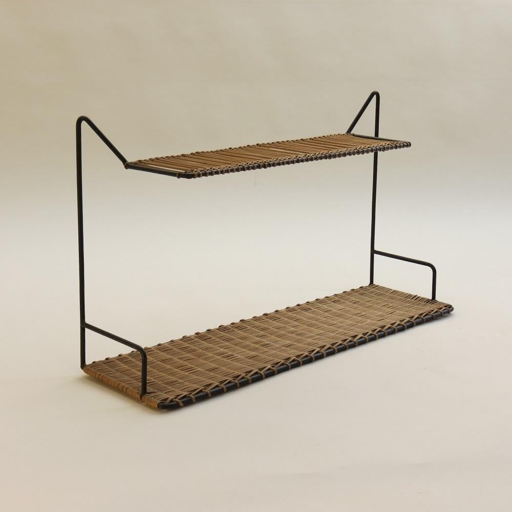 Rare and wonderful cane and steel shelf by Guy Raoul, France. All cane work intact and in perfect condition with very nice plated detail. Retains the original paint finish to the steel rod. Shelves hang from the two metal 'V' shapes. Good, quality