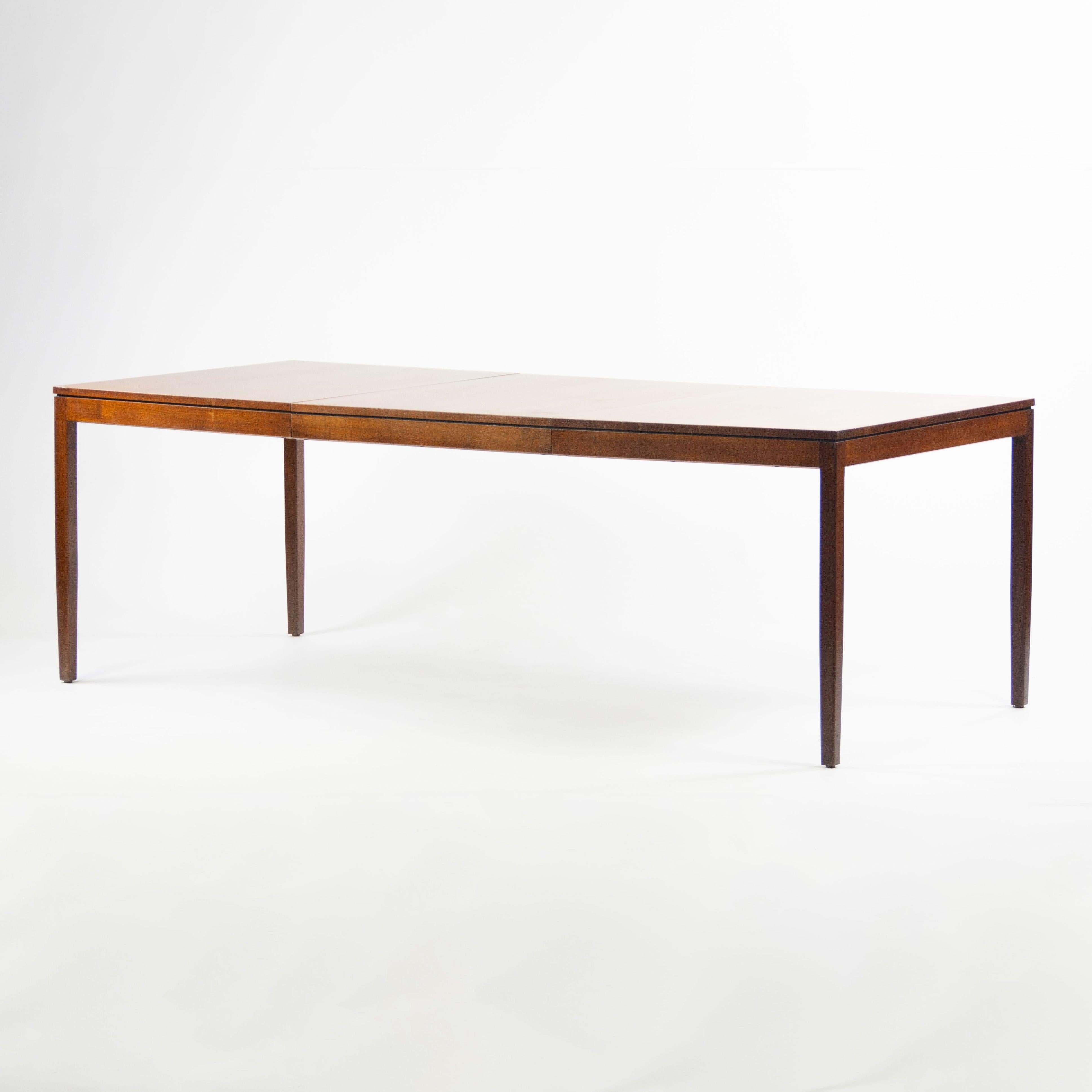 Listed for sale is a rare and stunning original Florence Knoll dining table in walnut. This example is a classic yet refined Florence Knoll piece, showcasing minimal lines and refined details.
The table includes one leaf, measuring 56 inches without