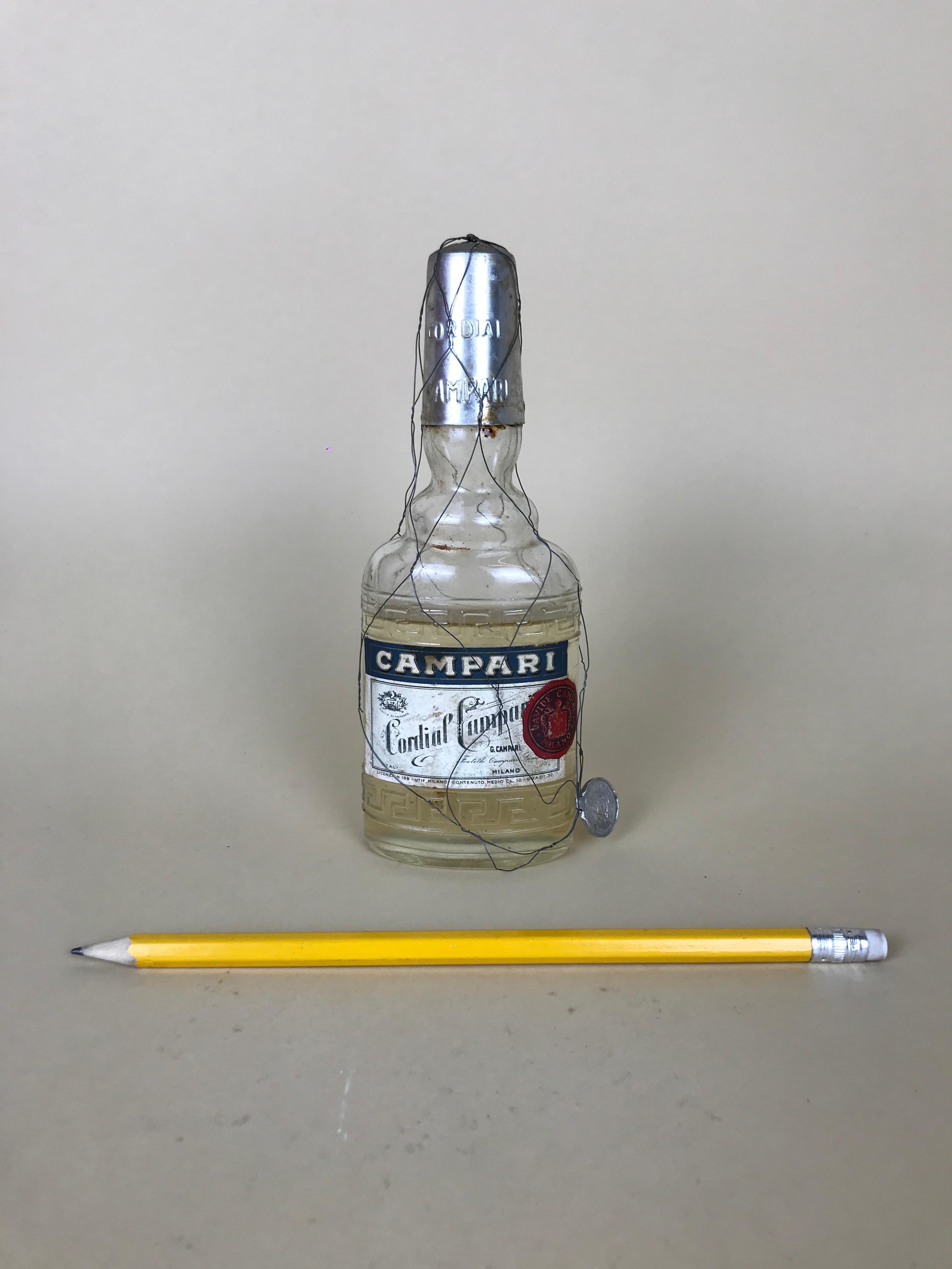 This rare vintage Cordial Campari glass flask is totally iconic! Both for its limited edition as bottle both because this Raspberry flavoured liqueur was produced only in the spring/summer season.

The bottle is full with original liquor with