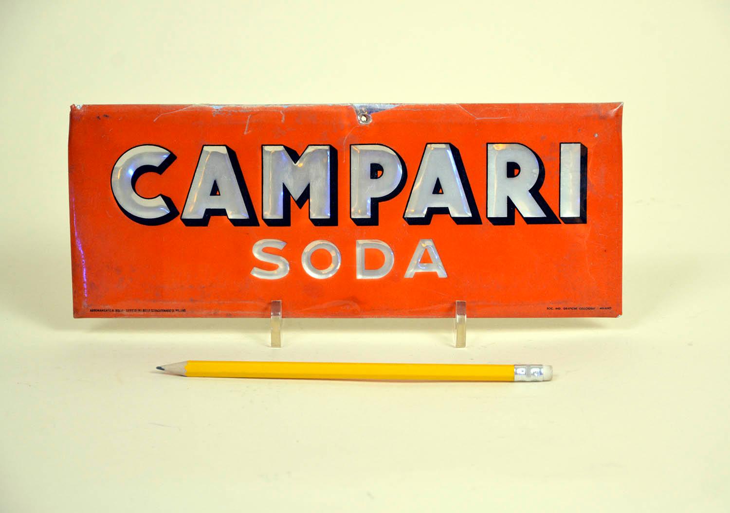 Rare vintage Campari Soda red sign, realized in foil laminated cardboard and made by Cellograf-Simp Milan, Italy in the 1950s.

The sign is slightly curved around the borders.

Collector's note:

Campari soda or Camparisoda is a single dose