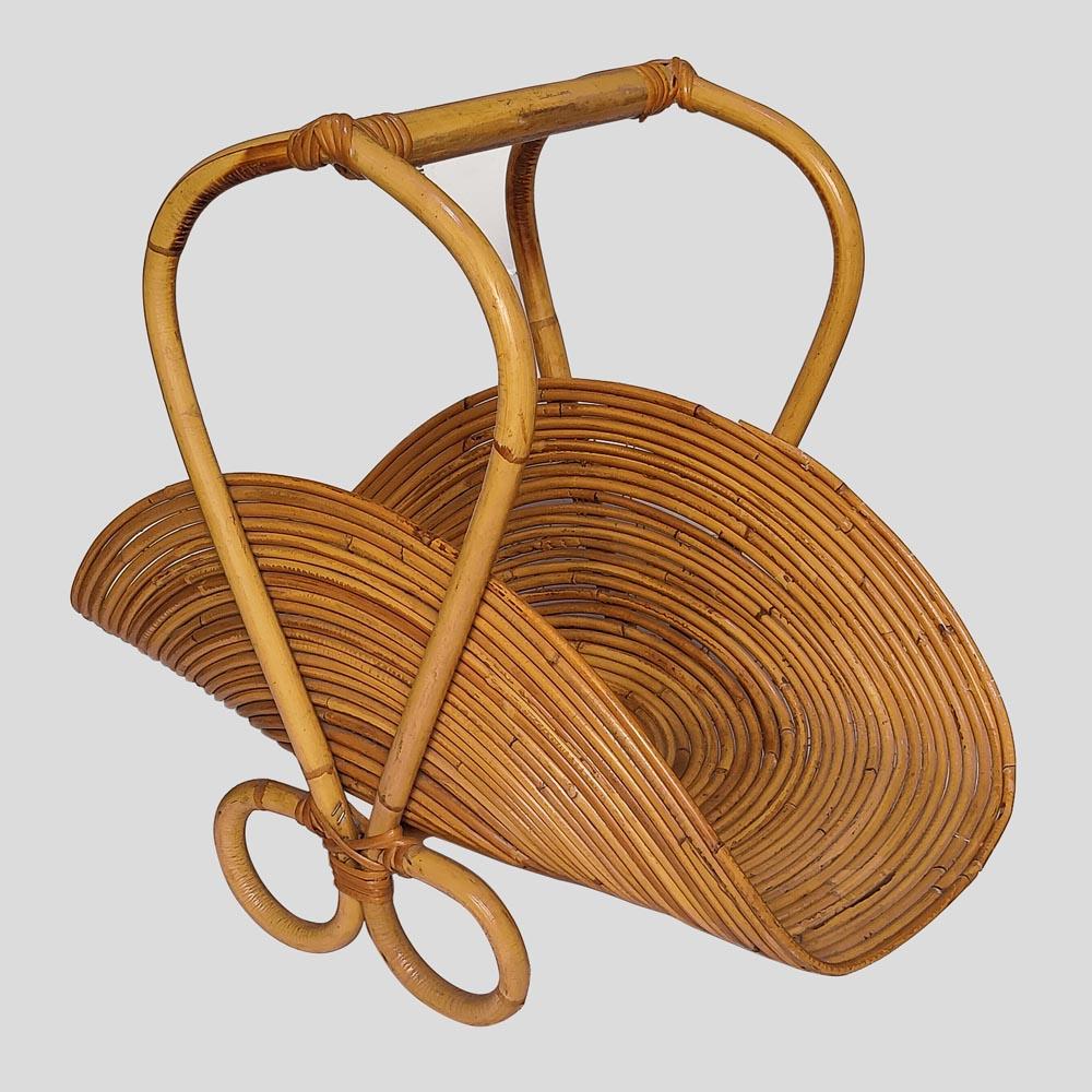 Vintage 1950s rattan magazine rack Italian design by Maker Vivai Del Sud.
This magazine rack is very representative of the happy spirit of the decade in witch was designed and produced. 
Also this is a very attractive basket shaped piece for the