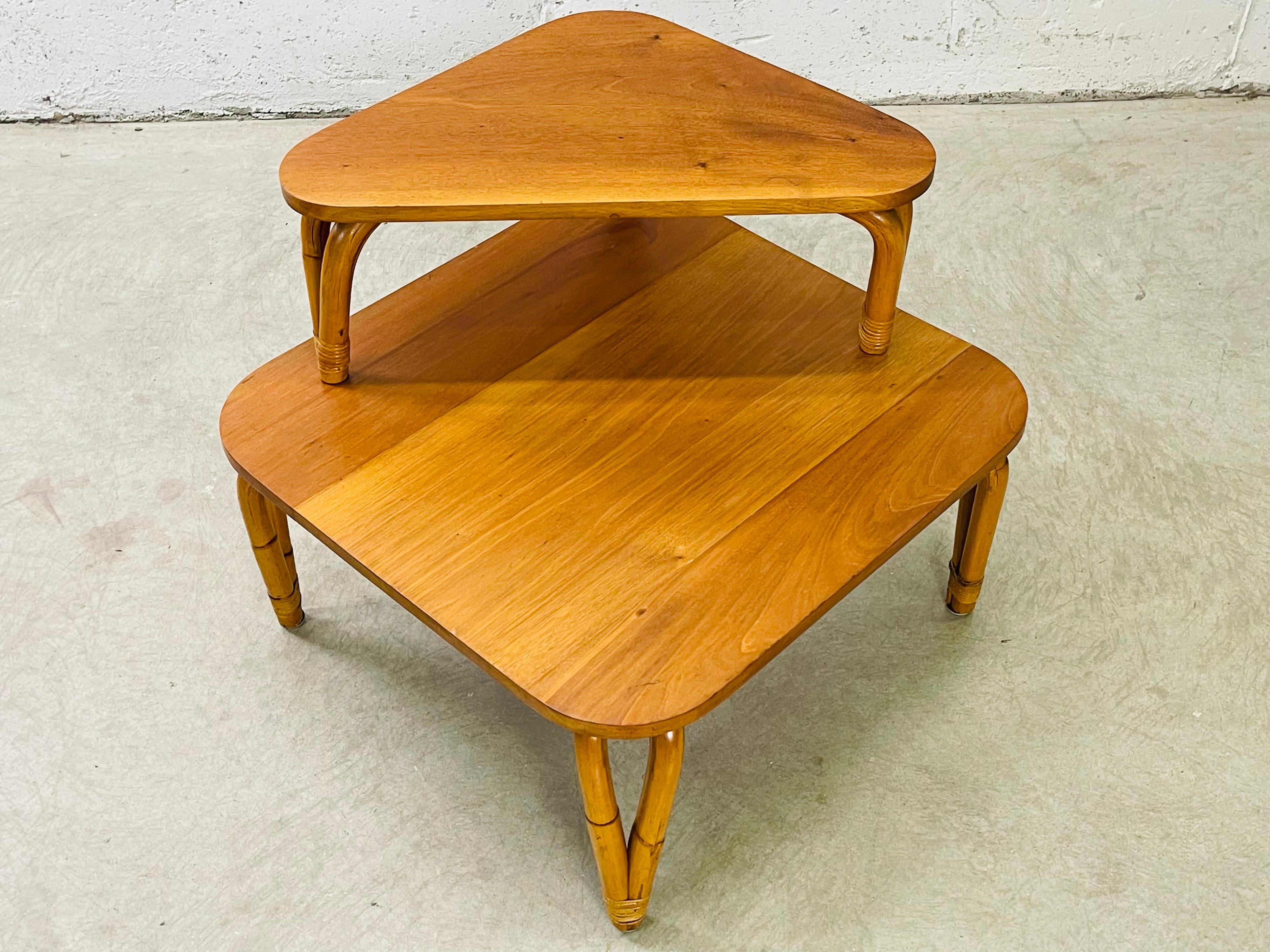 Vintage 1950s rattan and mahogany two tier corner table. The table is solid and sturdy with no breaks to the rattan. The first level is 14.5”H. No marks.