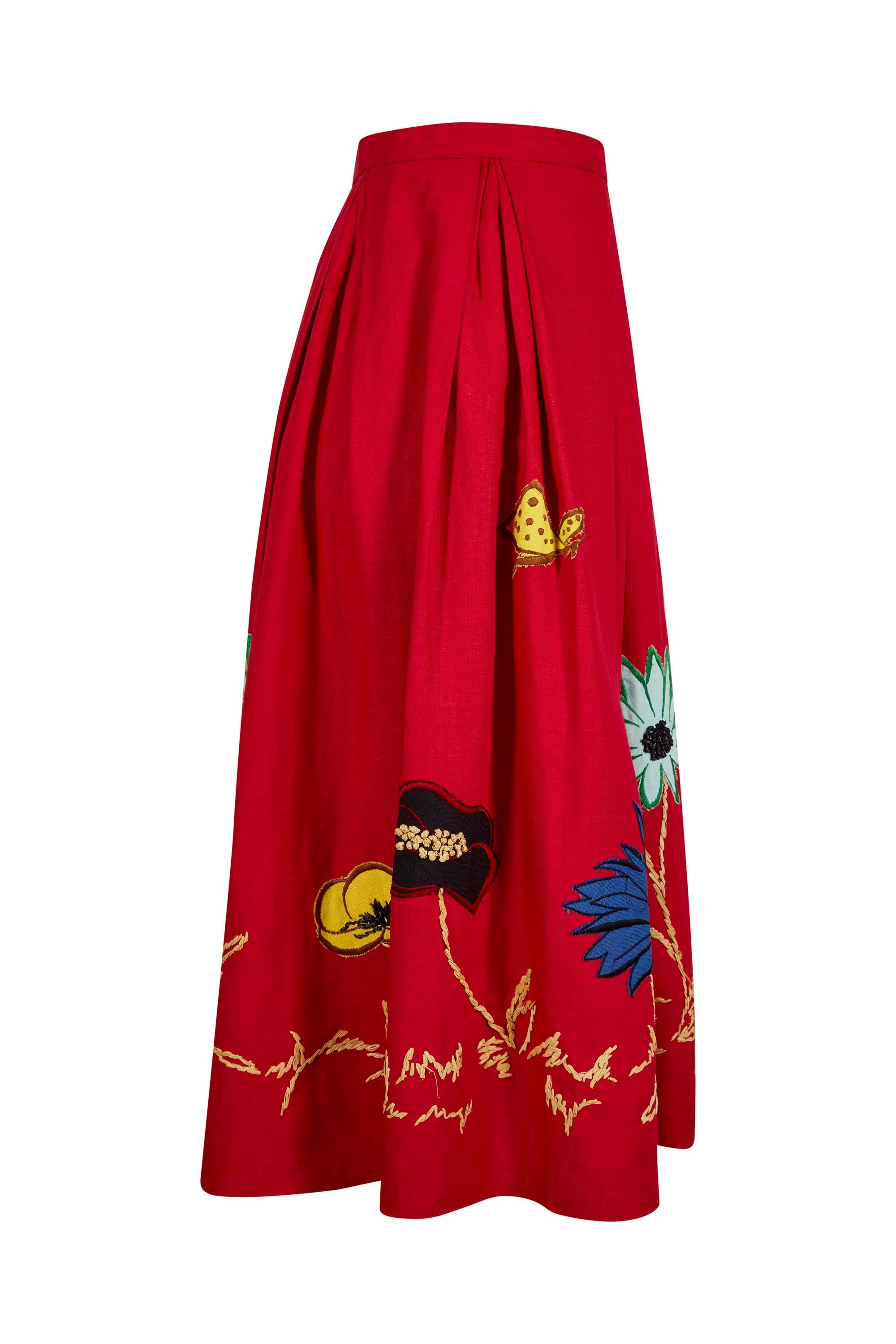 This vivacious 1950s red cotton skirt with large floral appliqué detail is from an unknown designer and is in excellent vintage condition having retained all of its vibrancy with a playful, contemporary aesthetic. 

The bold appliqué floral design