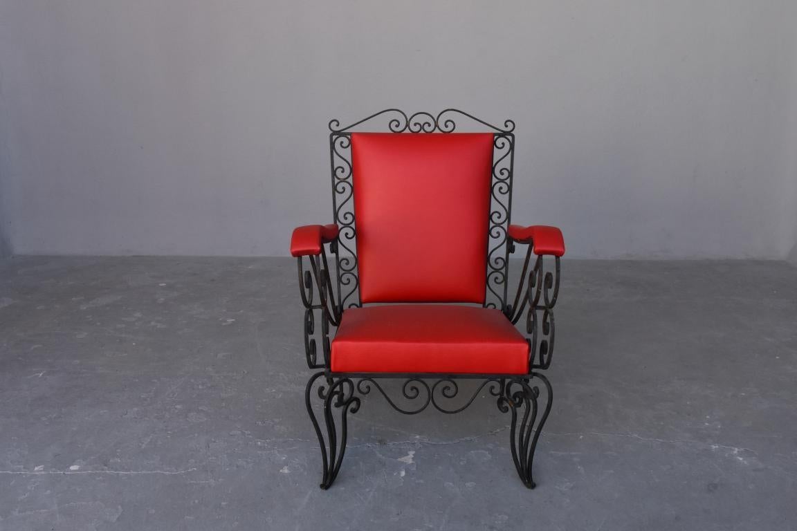 1950s red skaï covered wrought iron armchairs. Recently restored.