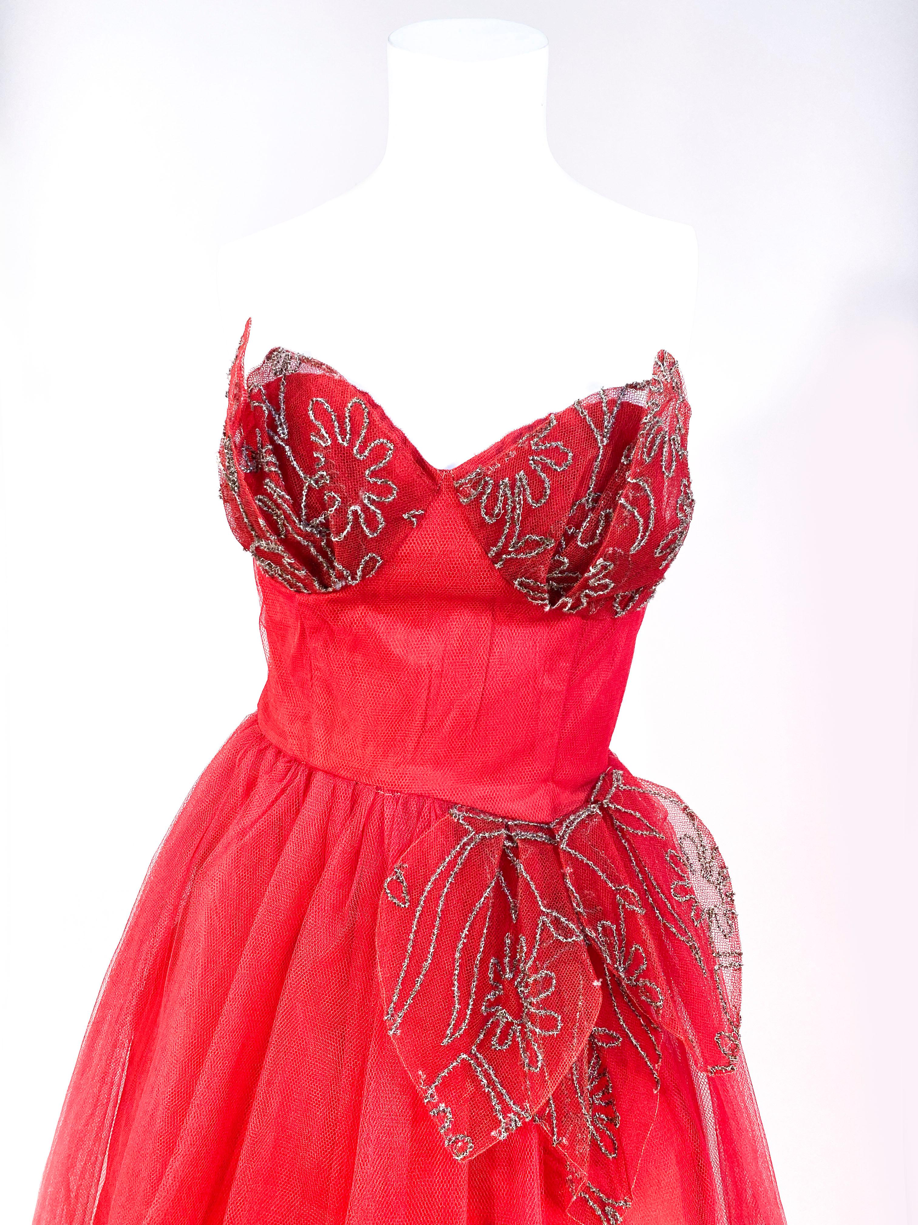 1950s red tulle tea-length party dress with decorative tulle petals with metallic broidery over the bust and adoring the waist. The dress is complete lined and the bodice is boned for structure. 
