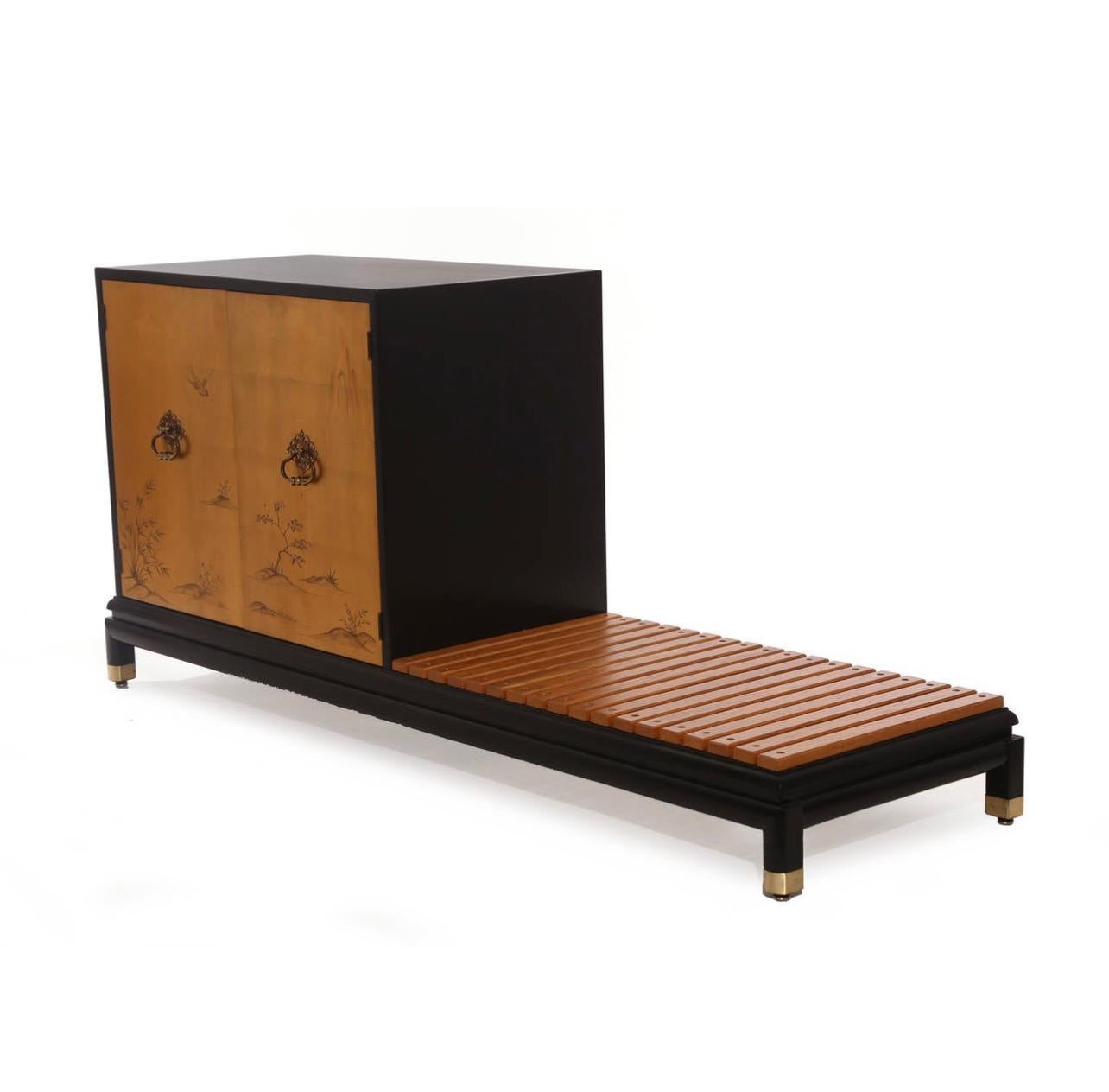 Renzo Rutili for Johnson Furniture Company chest with bench, circa late 1950s. It has gold leafed doors and ebonized case and bench. The interior of the chest has an adjustable shelf, and the case is finished on the front and back. It could be used