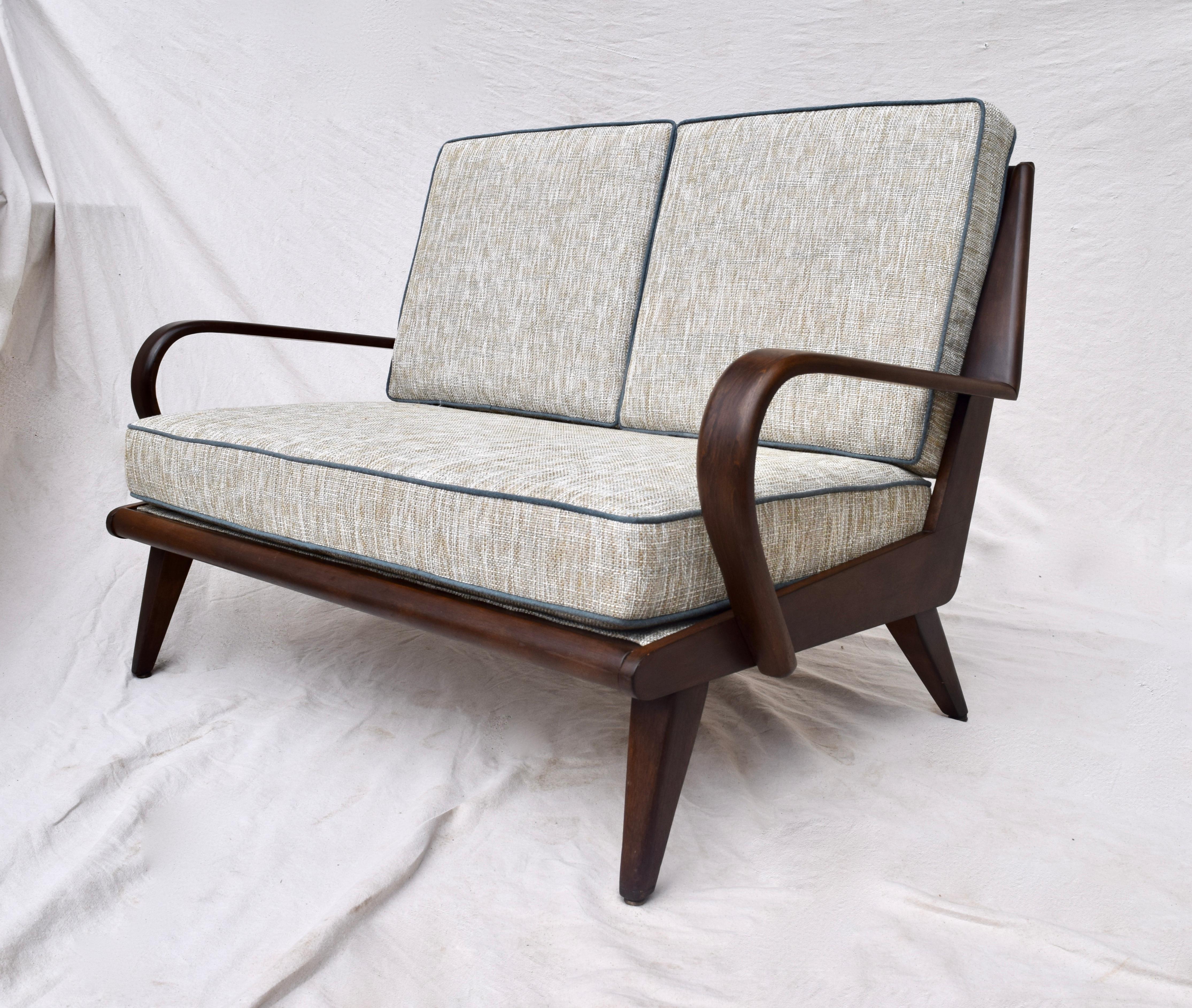 Heywood Wakefield 1950s Aristocrat series loveseat sofa. Fully restored and modified to a rich walnut finish revealing marvelous wood grains evident in the Danish modern influenced frame and bent wood arms. Features new custom cushions upholstered