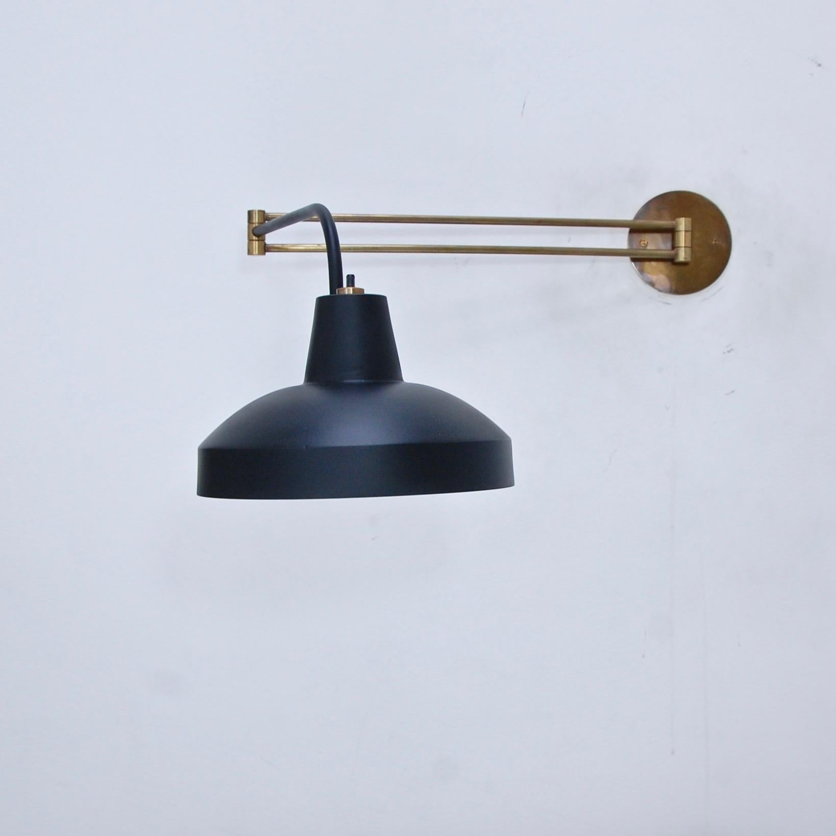 2 retractable Mid-Century Modern wall lights/sconces from Italy. Partially restored, patina lacquered brass, and painted aluminum. Single E26 based socket per sconce. Maximum wattage 75 watts per sconce. Back plate has 2 ¾” center to center mounting