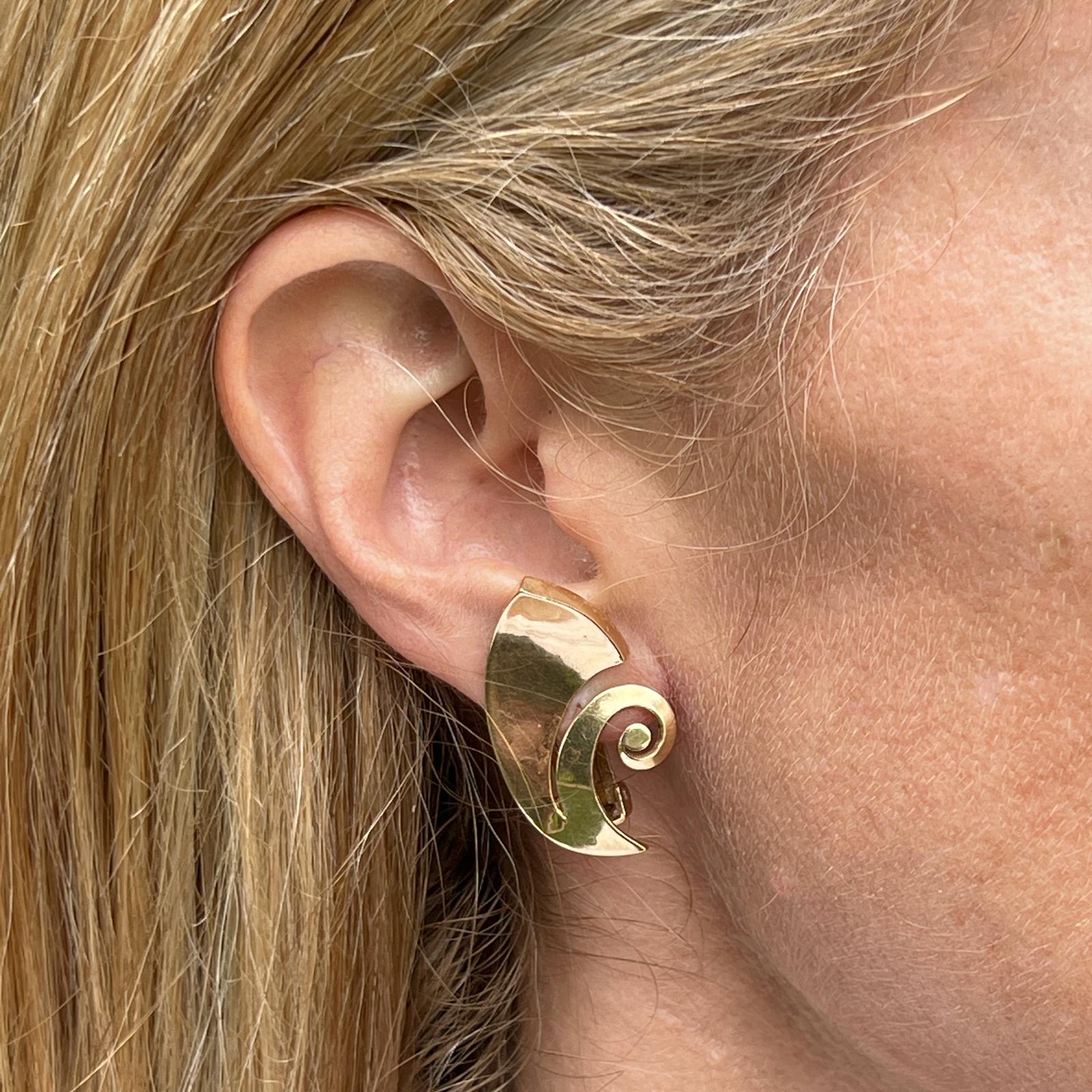 Retro swirl estate earrings handcrafted in 14 karat yellow gold. The high polish all gold earrings are light weight and measure 1.25 x .70 inches with clip backs (posts can be added). Great for everyday wear. 