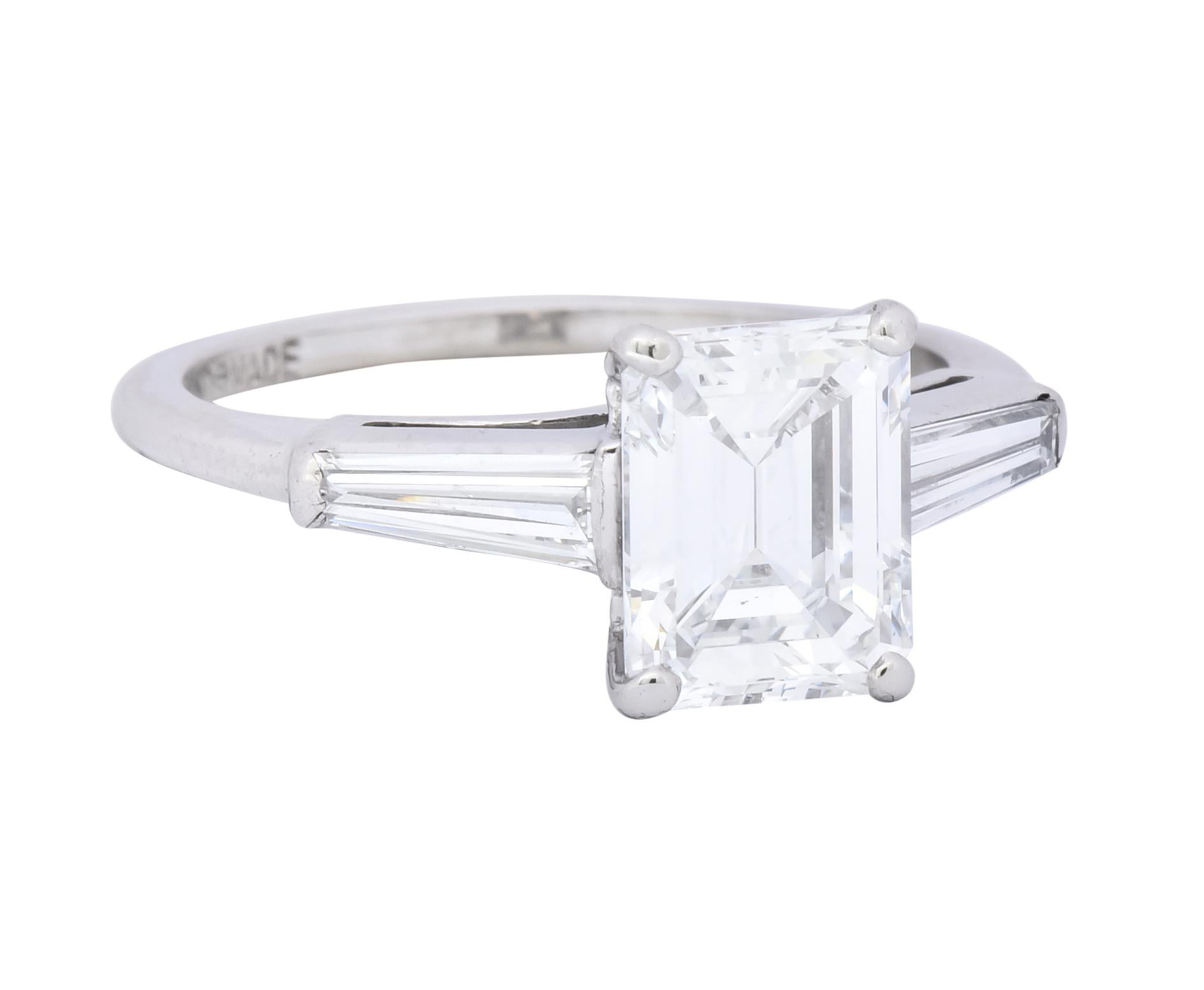 Centering a basket set emerald cut diamond weighing 1.63 carats, E color and VVS2 clarity

Flanked by two bar set tapered baguettes weighing approximately 0.40 carat total, E/F color and VS clarity

Stamped as handmade and 10% Irid Plat for