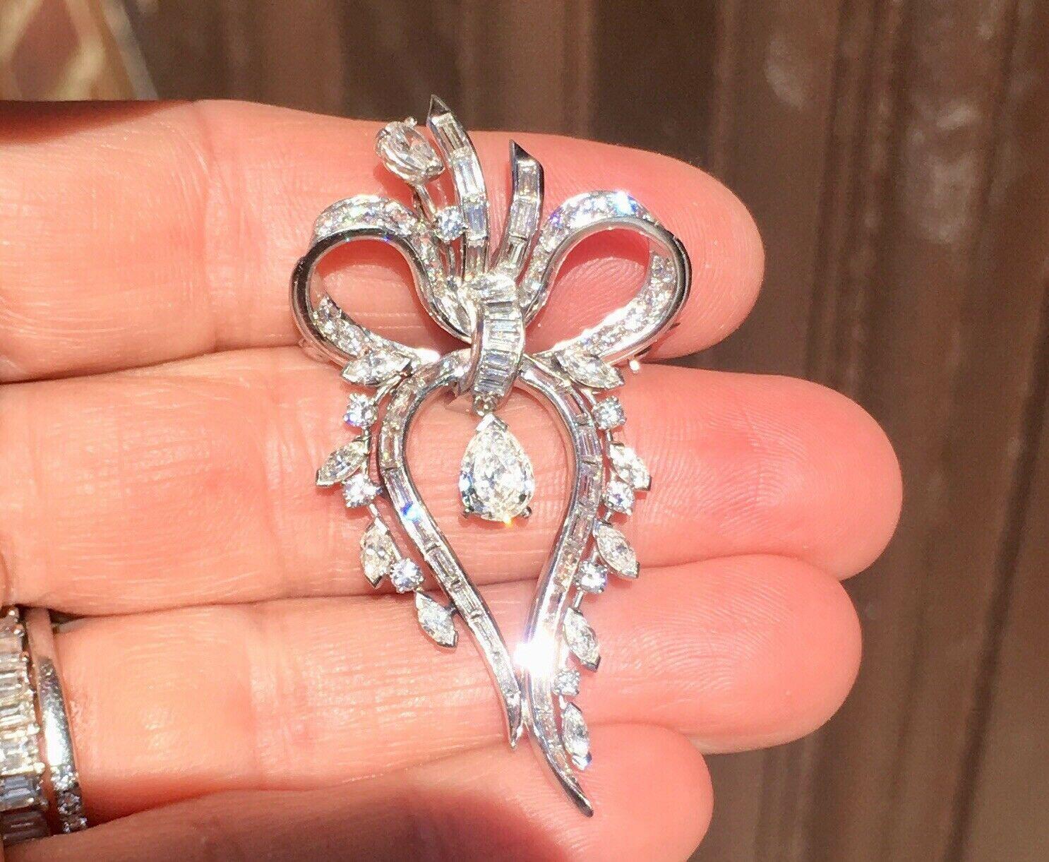 Stunning 1950s Retro Deco Platinum 3.00 ct G/VS Diamond Brooch Pin Pendant for Necklace

Stunning platinum pendant / brooch designed as a bow set with 
high quality G-H VS pear, marquise, baguette, and full-cut round brilliant diamonds.

Approximate