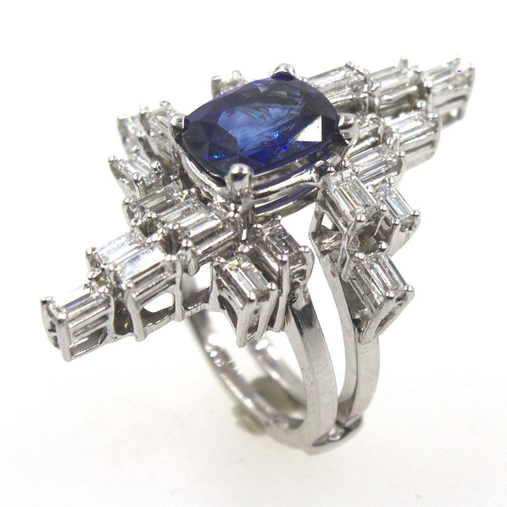 This fabulous ring circa 1950's features baguette cut diamonds in a geometrical shape surrounding a 4.35 carat cushion cut sapphire. The natural sapphire is noted to be of royal blue color on the GIA certificate. The 24 baguette cut diamonds equal