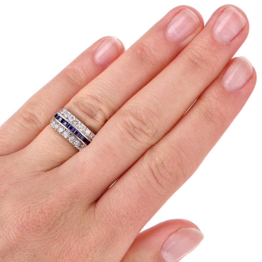 This vintage sapphire and diamond band ring is crafted in solid platinum. Ring features 7 step cut genuine blue sapphires approx. 0.50 carats and 14 round-cut diamonds approx. 0.75 carats, H-I color, VS clarity. Measures 8 mm wide x 4mm height and