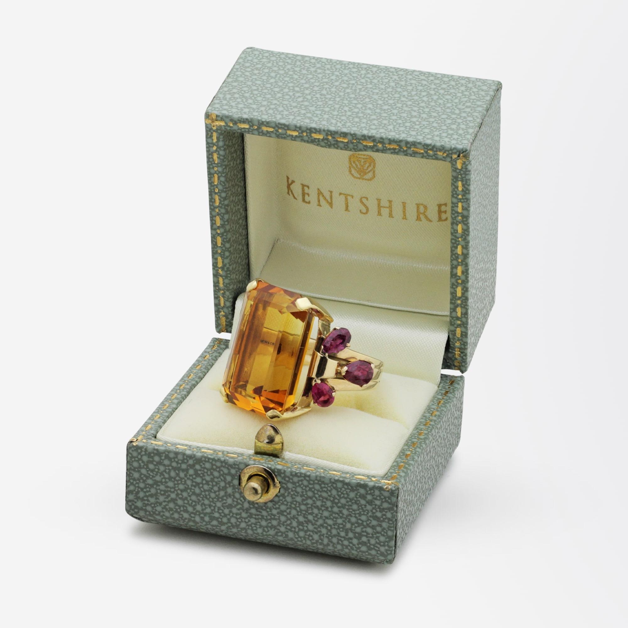 An impressive cocktail ring from the 1950s by famed American jeweller, Tiffany and Company. This ring centres on a large octagonal cut, honey coloured citrine that has three pear shaped rubies on each shoulder. The ring which has been handcrafted in