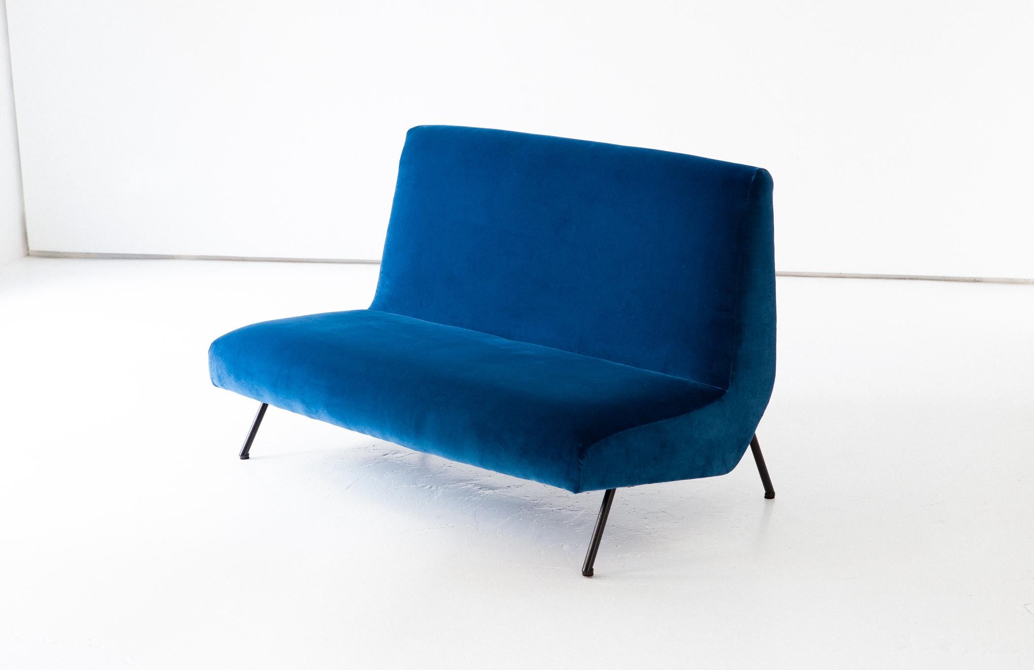 Mid-Century Modern sofa, designed and produced in Italy during the 1950s.

The upholstery is new with high quality 100% cotton blue velvet, we have also worked on the iron legs with new black enamel.
We consider that the seat is very