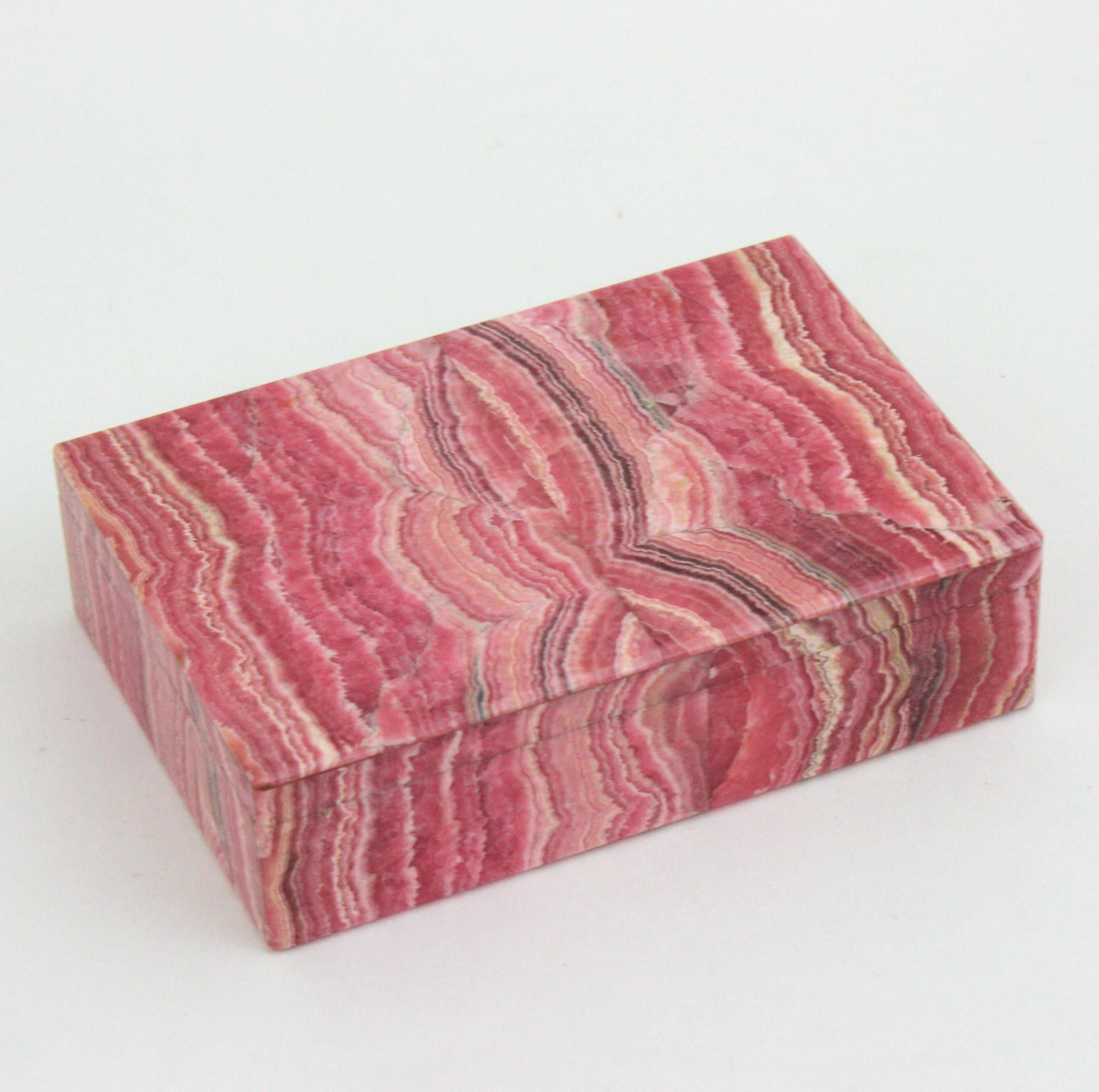Outstanding Mid-Century Modern hinged box veneered in fine Rhodochrosite, Spain, 1950s.
Rhodochrosite is a rare mineral, used in many decorative forms including jewelry. In its rare pure form its typically a rose-red color. 
This exquisite vintage