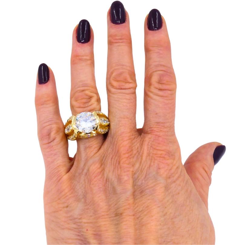 Circa 1950s ring, made of 18k gold, featuring an Old European cut diamond.
This bold mid-century ring is a true statement piece, built around a substantial 5.23-carat Old European cut diamond. Graded O-P in color with SI1 clarity, the center diamond