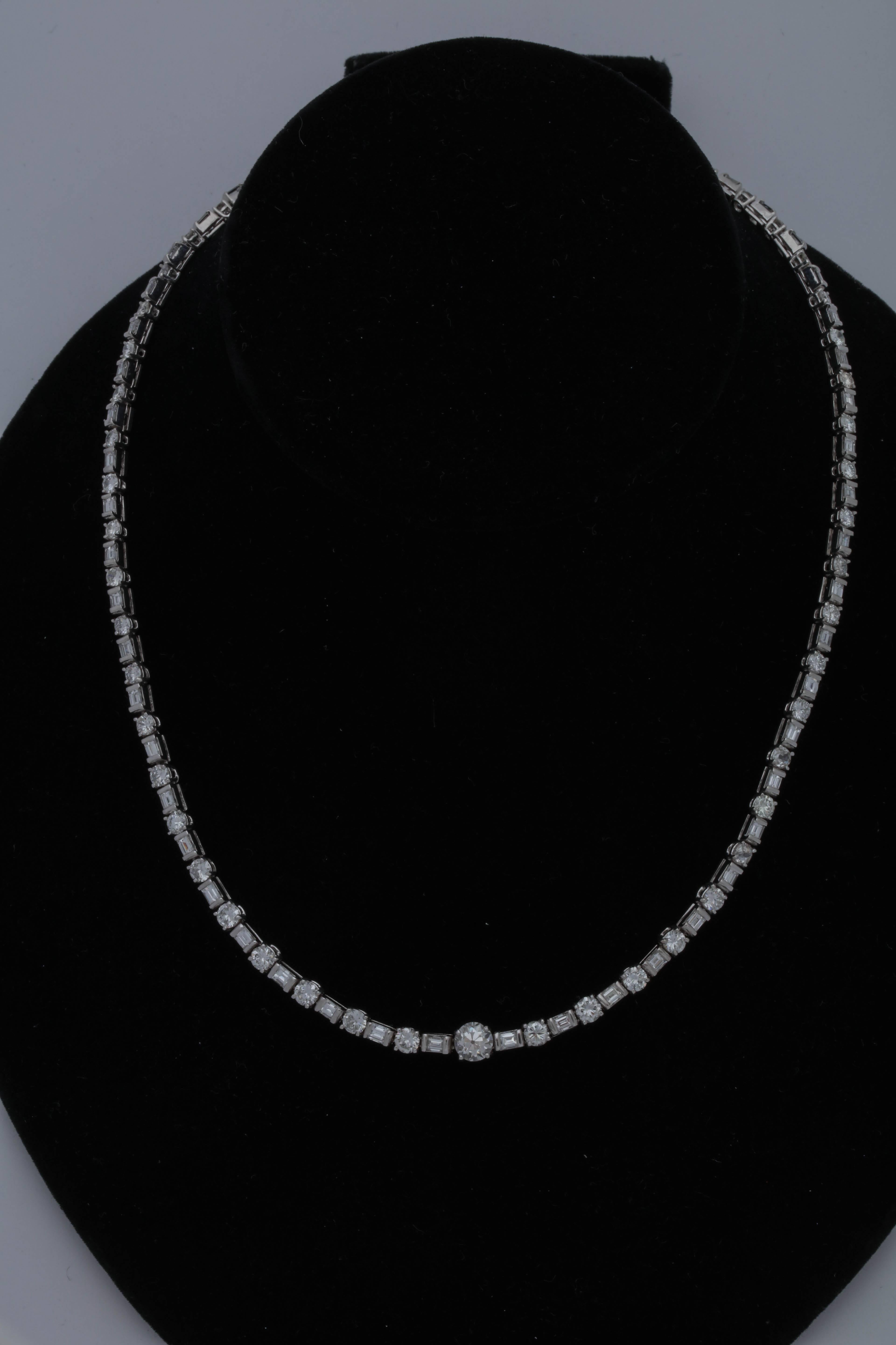 One Ladies Platinum Necklace Designed In a Riviere Style Flexible Straightline Motif. This Platinum Necklace Is embellished With Numerous Alternating High Quality Horizontal Baguettes And With Alternating Prong Set Full Cut round diamonds . Total