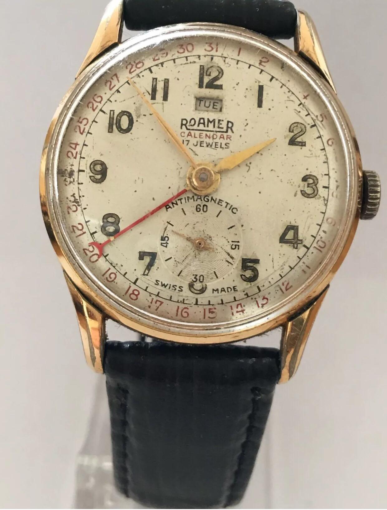 1950’s Roamer Calendar Hand-Winding Wristwatch.

This watch is working and running well. The Dial has aged. The Gold plated watch case is a bit tarnished as well as the winder. The black strap is torn near the buckle as shown on the photo. Please