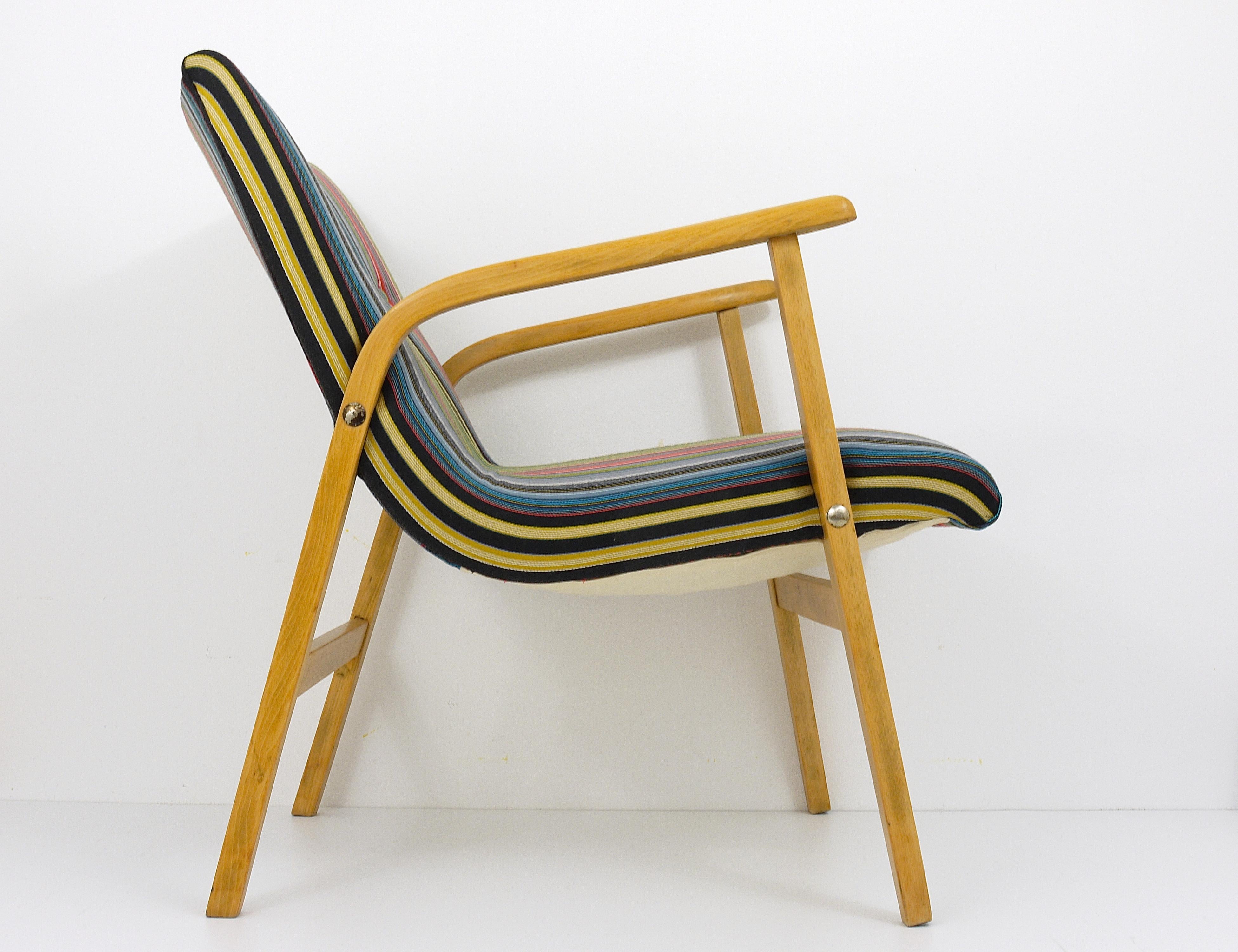 A beautiful midcentury armchair, designed by Roland Rainer in 1952 for the well known Café Ritter in Vienna . In excellent condition, gently restored and reupholstered with exclusive original Paul Smith fabric by Maharam NY. An eye-catching chair.