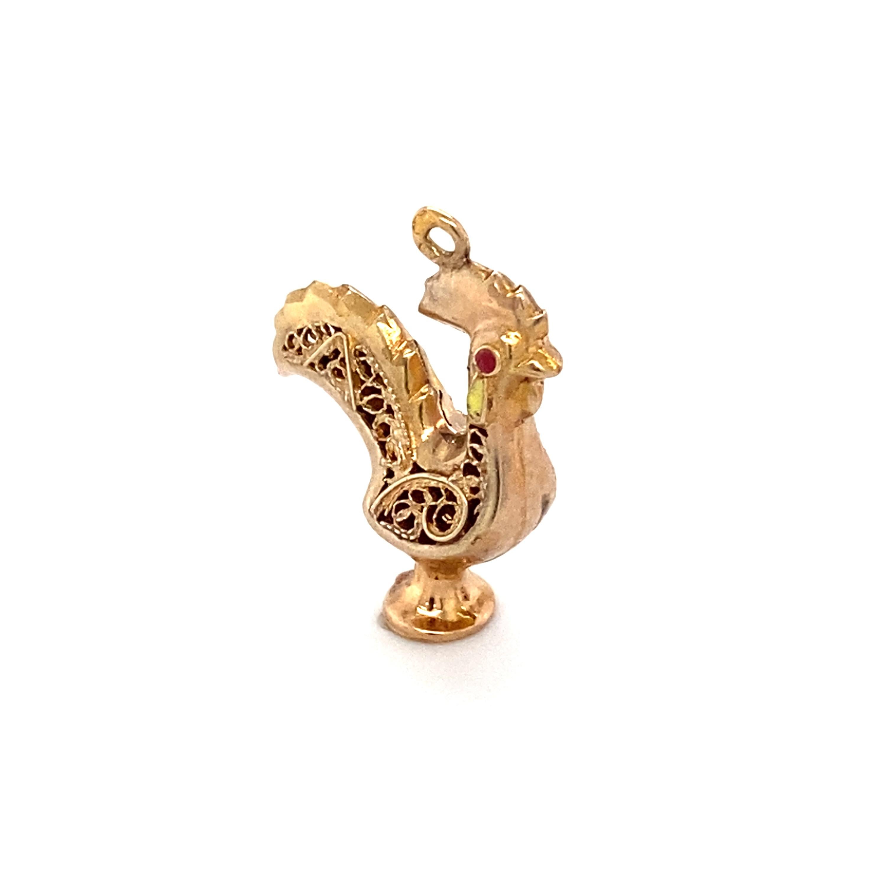 Item Details: 
Metal: 19 Karat Yellow Gold
Weight: 1.7 grams 

Item Features: 
This stunning rooster charm has intricate filigree design and a small ruby eye all set in 19 karat yellow gold. 