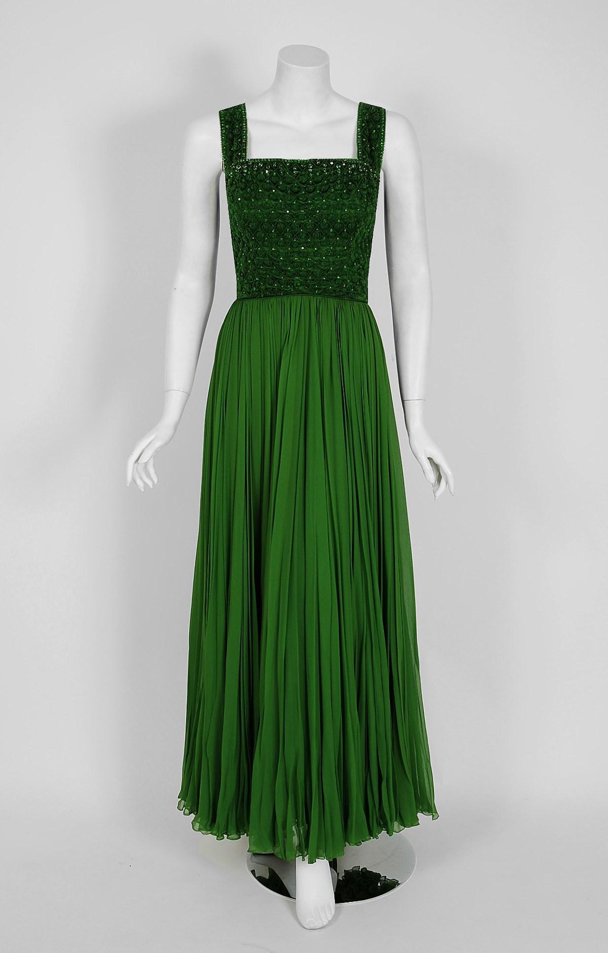 Rosalie Macrini had her start designing for the famous Barbara Costume Company in New York, going on to buy the business in 1954. Macrini was best known for opulent evening looks and for her unique use of extravagant fabrics. This breathtaking olive