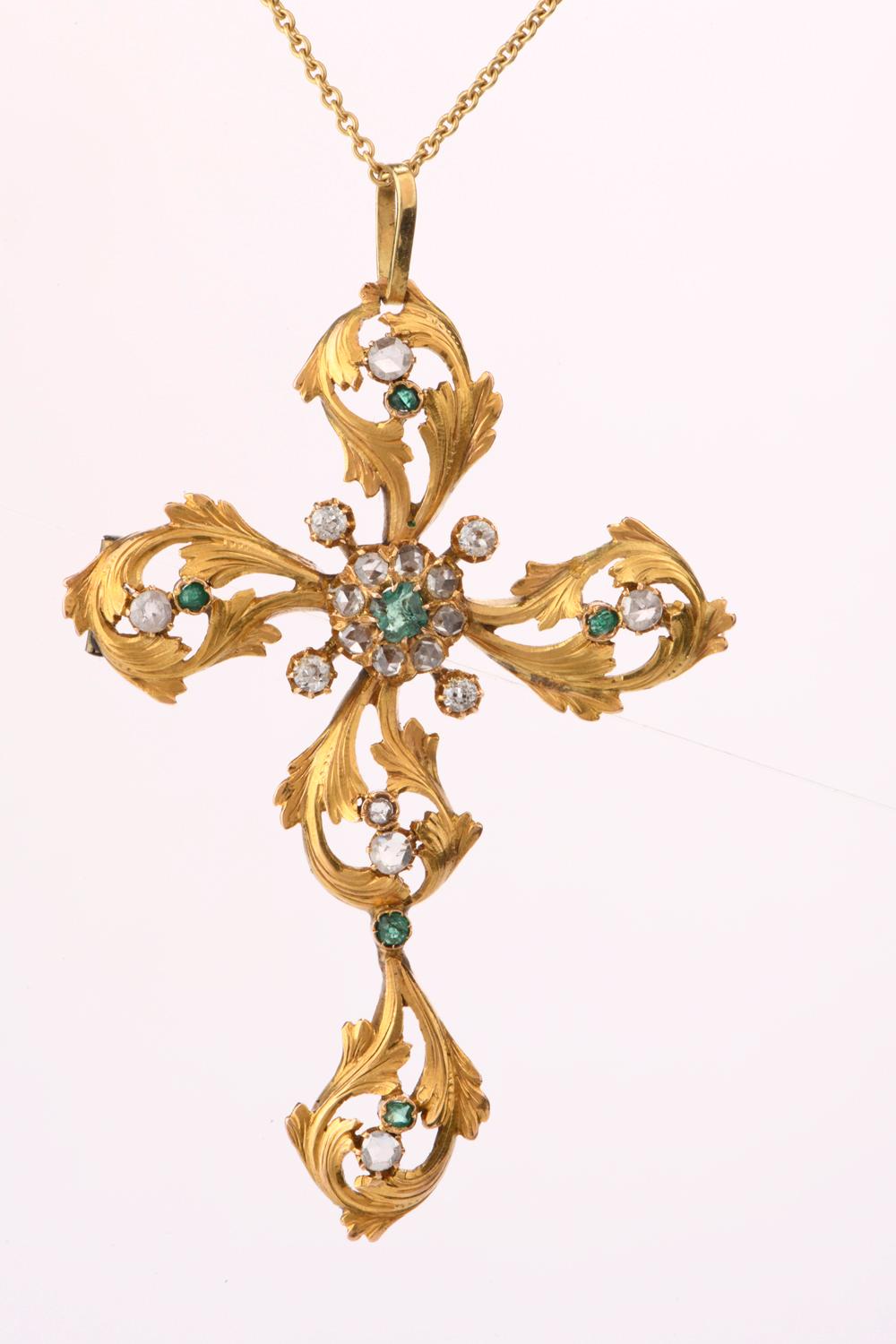 This large vintage Pendant Brooch was inspired in a leaf patterned cross and crafted in 18K yellow gold.

A continuous pattern of leaves run throughout and are embellished with rose cut and European cut Dimaonds and Emeralds.

Diamonds weigh appx.