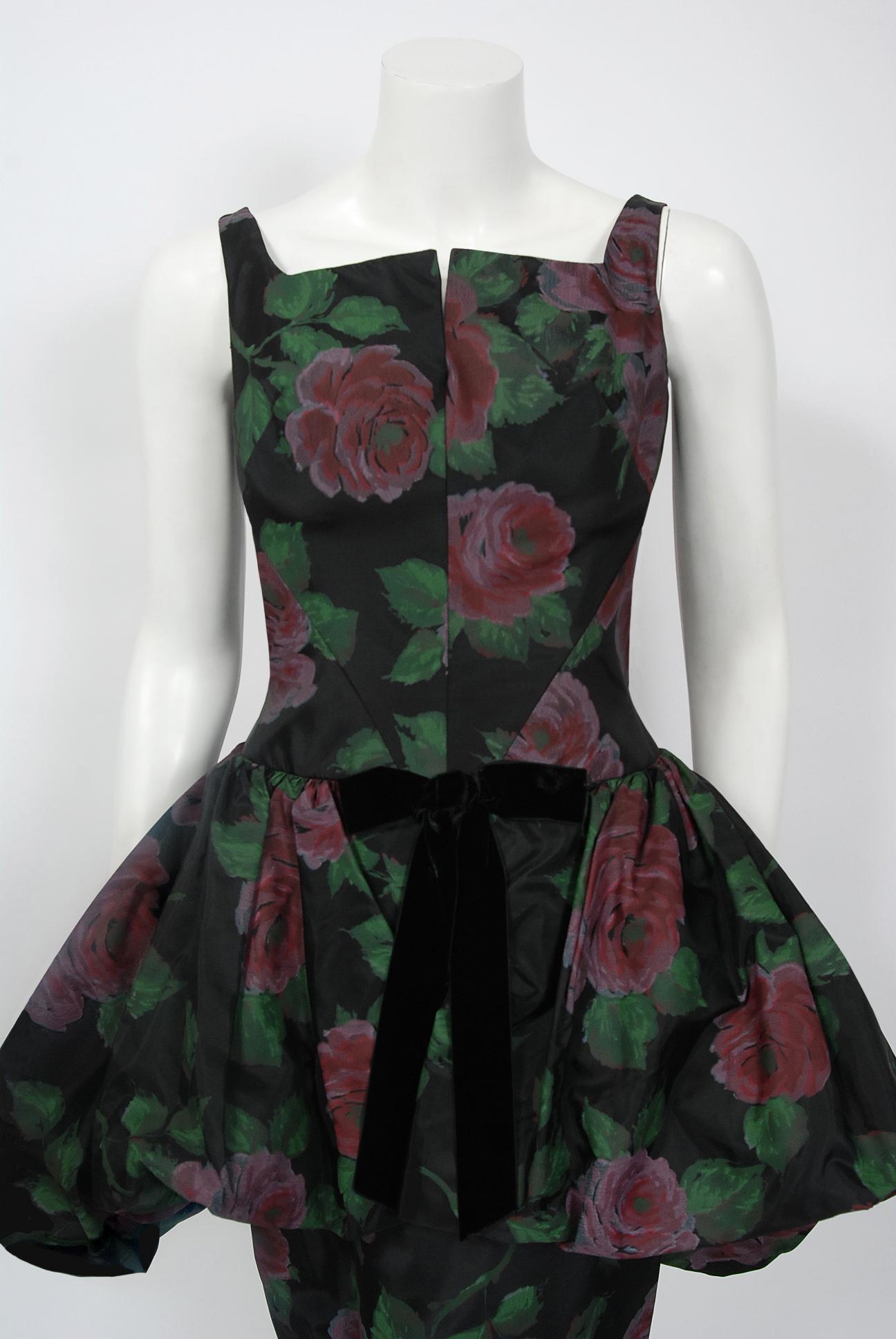 In this gorgeous 1950's rose-print cocktail dress, the detailed construction and meticulous attention to detail are comparable to what you will find in modern couture. The garment is fashioned in mid-weight silk taffeta with the prettiest large