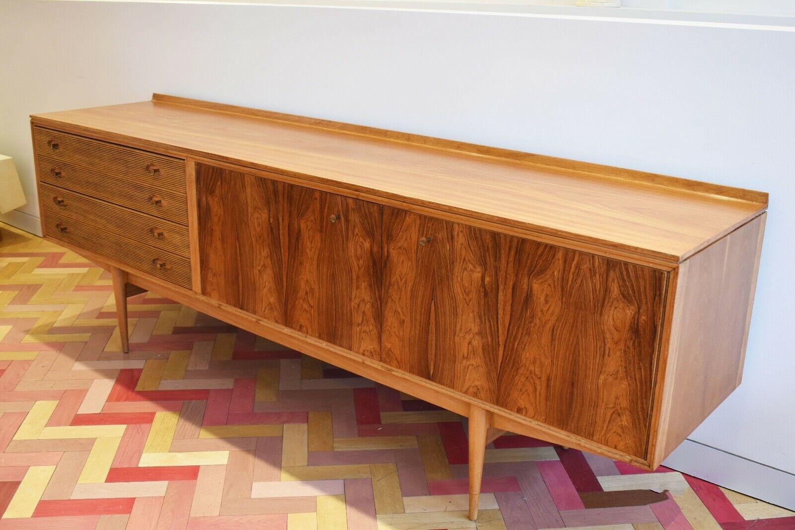 Mid-century rosewood Hamilton sideboard / credenza designed by Robert Heritage and manufactured by Archie Shine, England, circa 1950s, this elegant Danish style design with long rectangular top over four reeded drawers with two cupboards, having