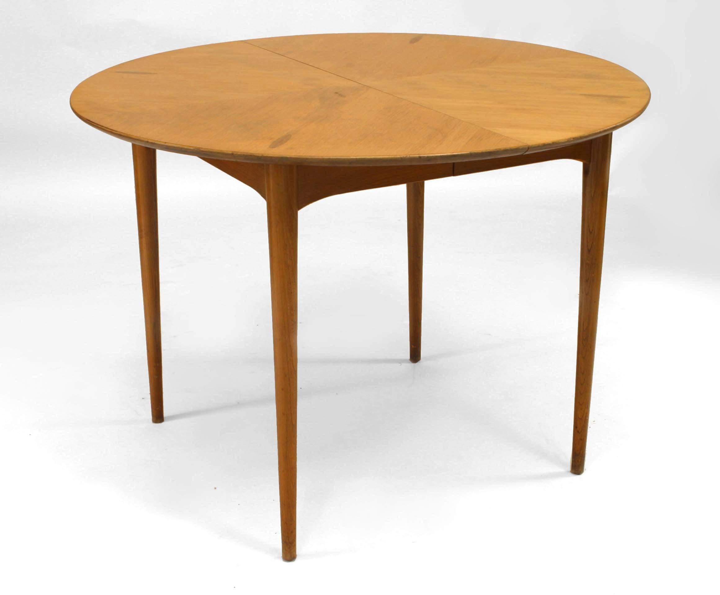 Post-War Design Danish-style (1950s) light wood round dining table with 4 small oval inlaid sections supported on 4 conical form legs (originally had leaves)
