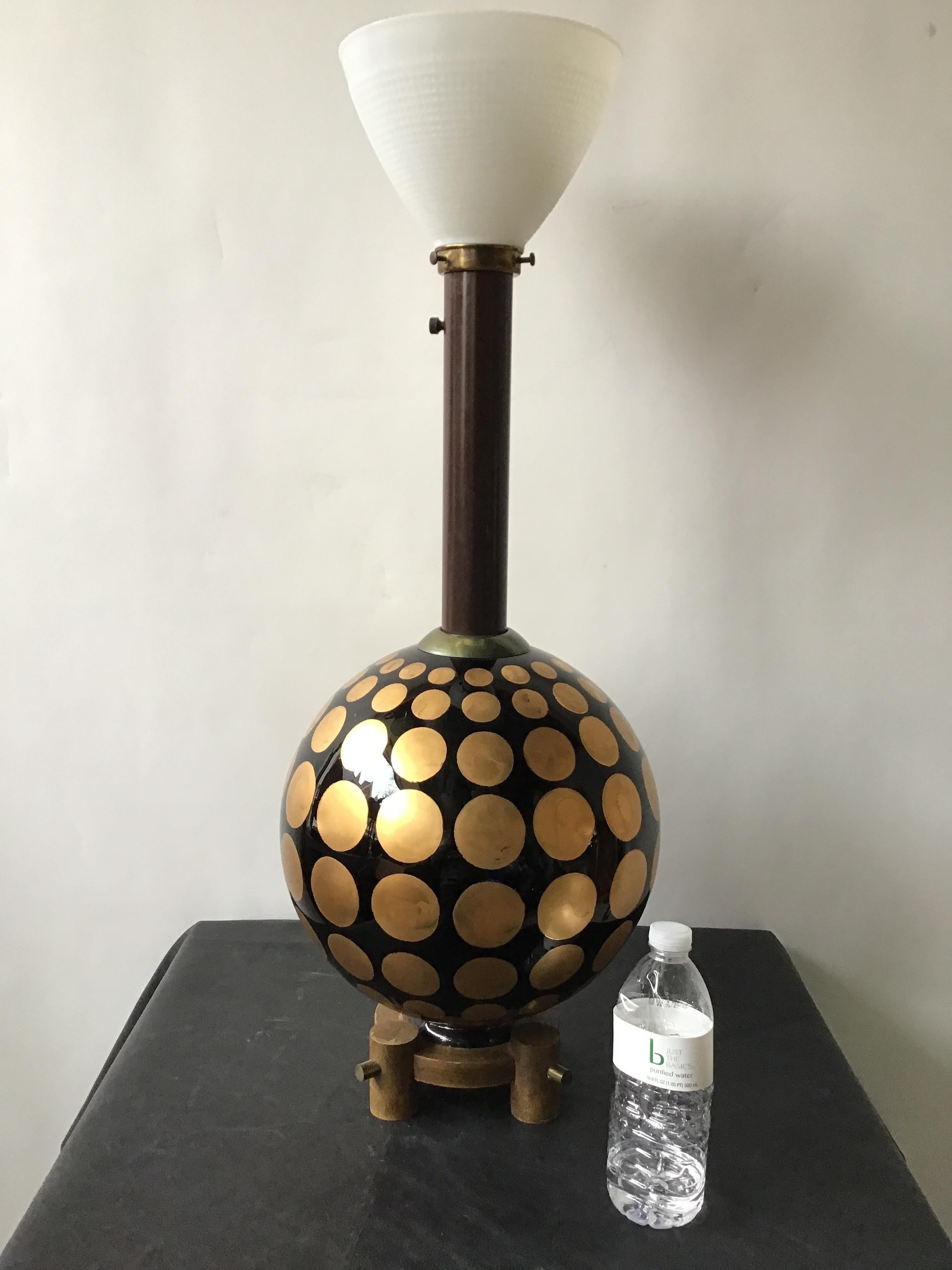 1950s round glass lamp with hand painted gold circles. On wood base with brass accents.