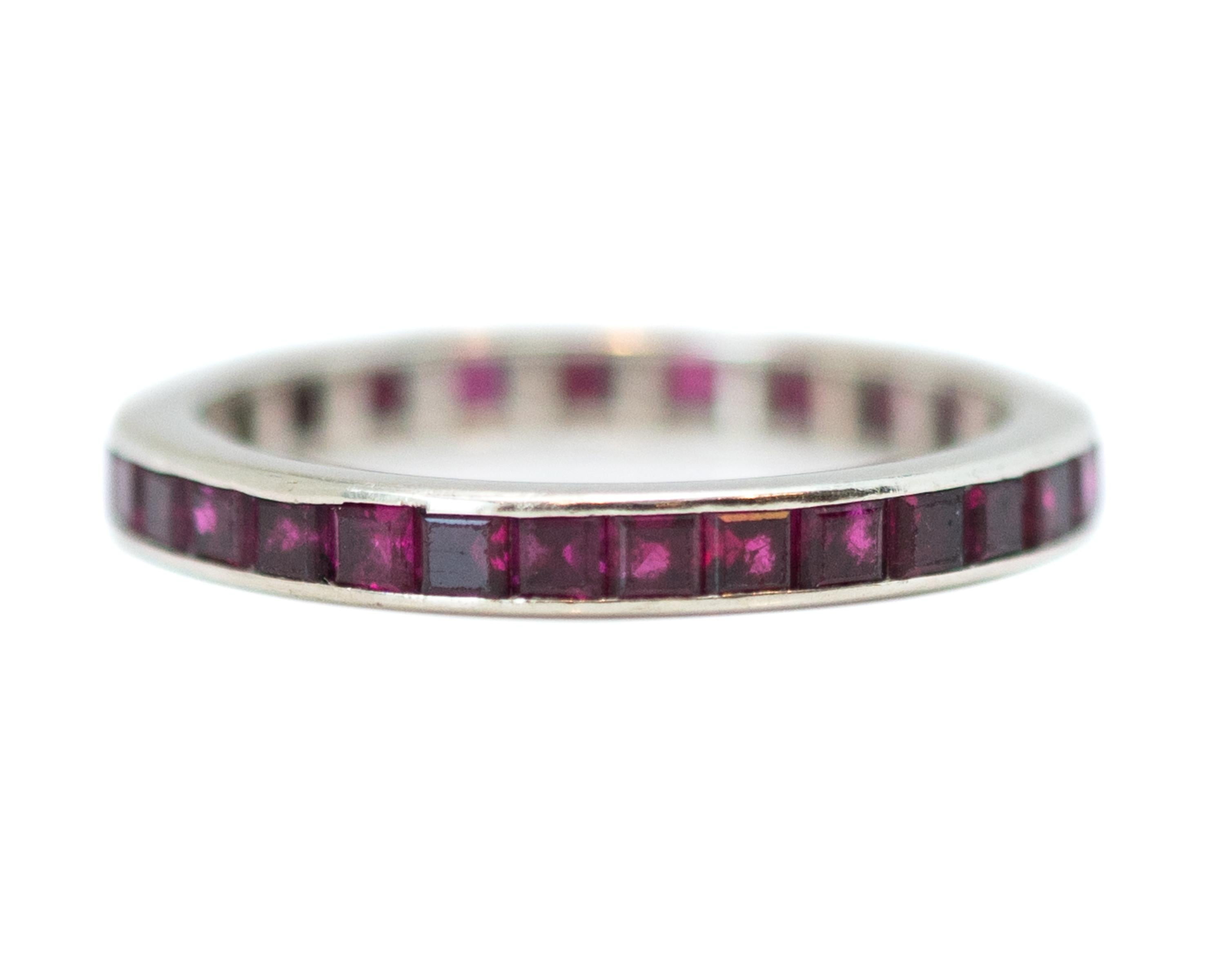 1950s Retro Ruby Eternity Band - 14 Karat White Gold, Rubies

Features:
Emerald cut Rubies 
14 Karat White Gold Setting
Channel set Stones
Deep pinkish red Rubies

2.5 millimeters wide
Finger to top of stone measures 2.0 millimeters
Fits size 6 1/4