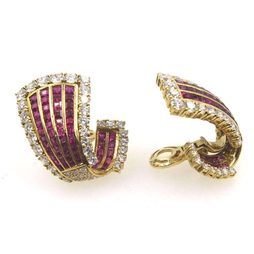The stunning ruby and diamond earrings make a statement on the ear. The earrings can be worn with post or clip (post is retractable). Beautiful rows of square faceted red rubies are outlined with 70 round brilliant cut diamonds. The earrings measure