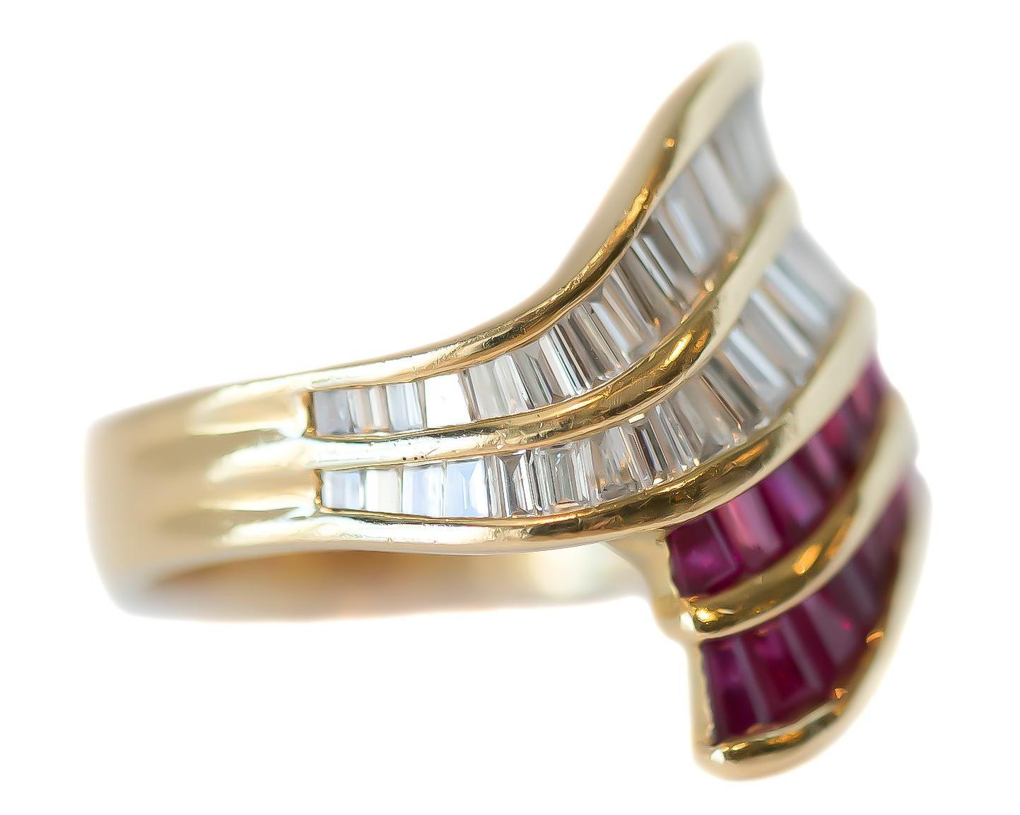 1950s Retro Ruby and Diamond Cocktail Ring - 18 Karat Yellow Gold, Rubies, Diamonds

Features:
0.96 carat total Baguette Diamonds
1.43 carat total Baguette Rubies
18 Karat Yellow Gold 
Elegant Bypass Design
Channel set Stones

Ring Tapers from 20 -