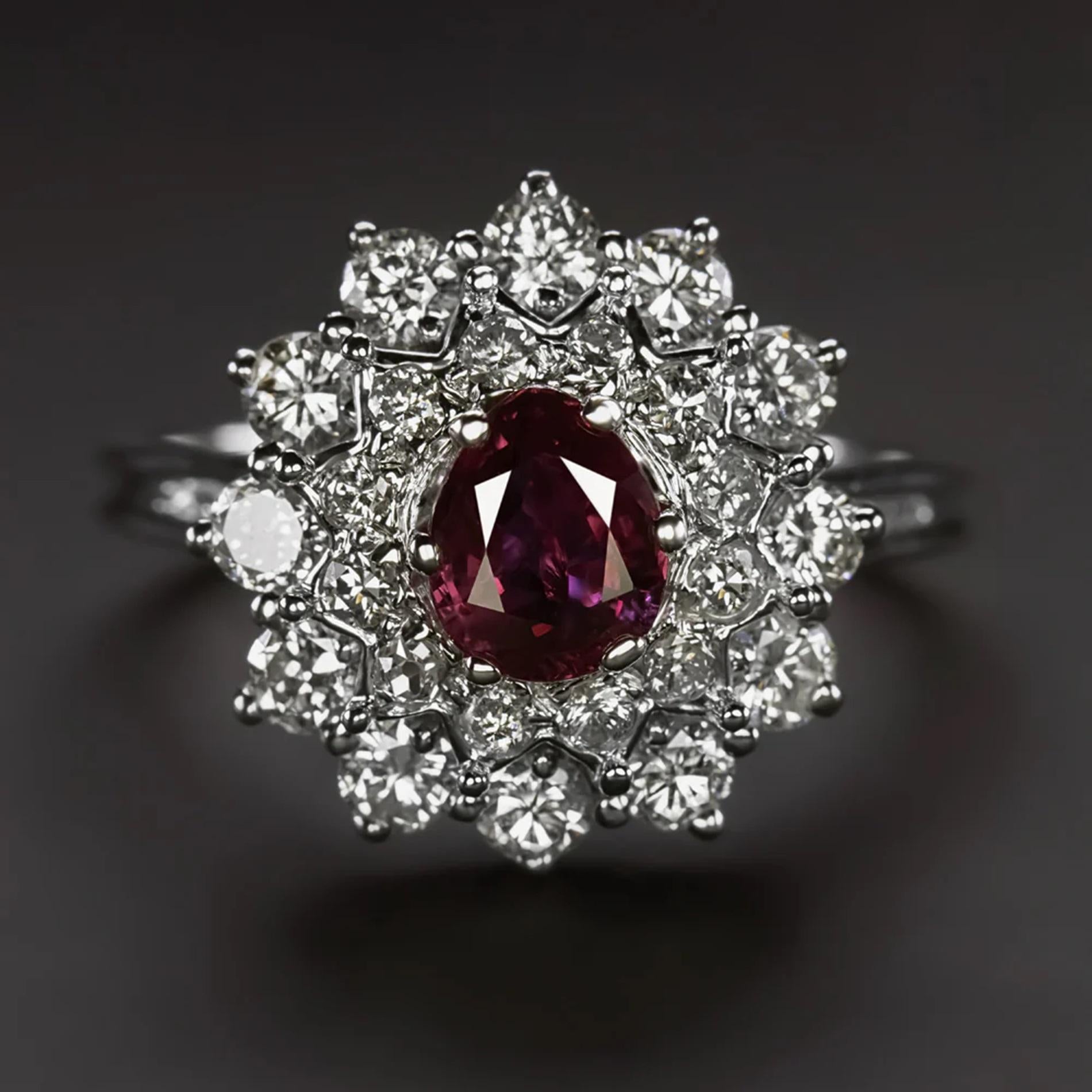 Presenting a mesmerizing ruby and diamond ring that captivates with its stunning design, featuring a brilliant pear-shaped ruby encircled by a vibrant double halo of diamonds. This exquisite piece commands attention with its large and eye-catching