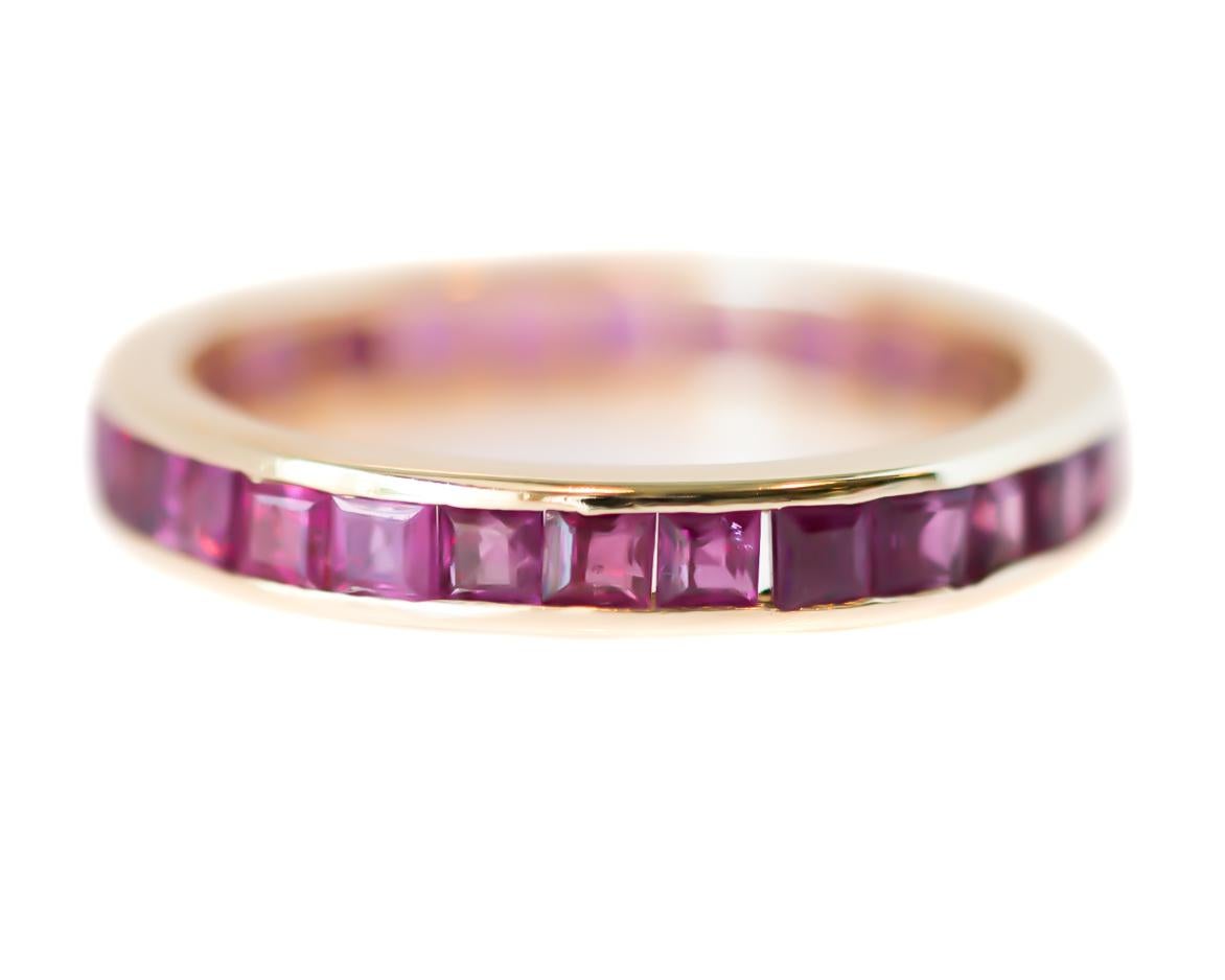 1950s Retro Ruby Eternity Band - 14 Karat Yellow Gold, Rubies  

Features:  
3 millimeter wide band 
Channel set, square French cut Rubies 
Pinkish-red rubies 
14 Karat Yellow Gold High Polish Setting 

Ring fits a size 6  

Ring Details:
Size: