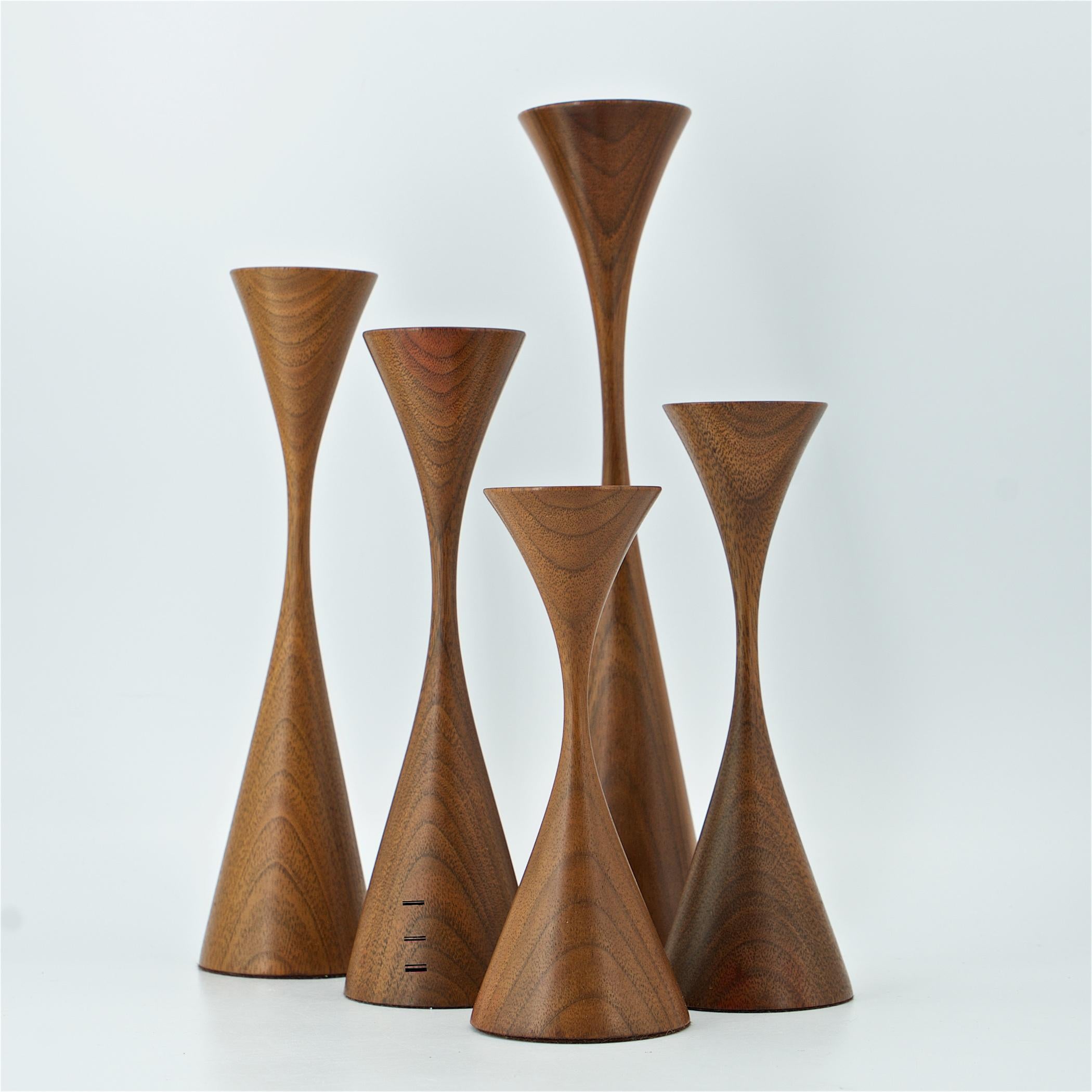 Wonderful and Iconic hand turned and weighted walnut candlesticks in graduating heights. All with OO signature on the felt. 

Measures: H: 11 3/8, 9 5/16, 8 1/4, 7 3/8, 6 1/4 in.

