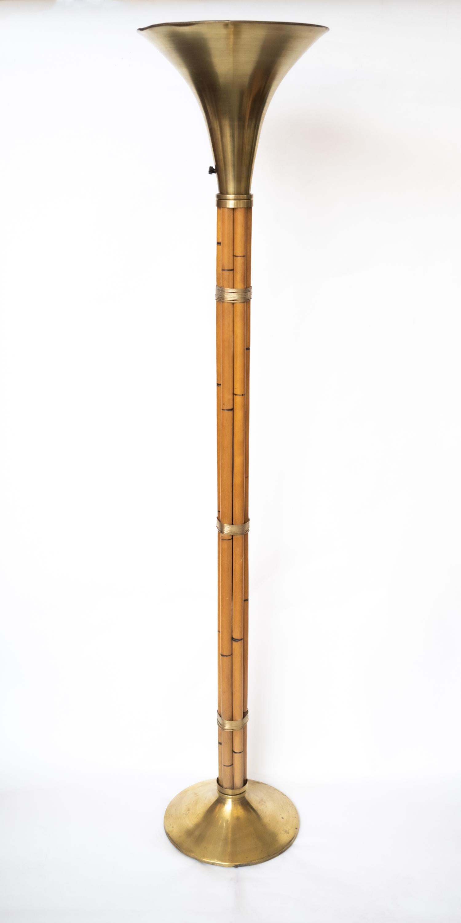 A brass and faux-bamboo floor lamp by American designer Russel Wright (1904-1976) for Raymor having maple rods wrapped in solid brass wire with bases and tops made in solid spun brass, circa 1950.