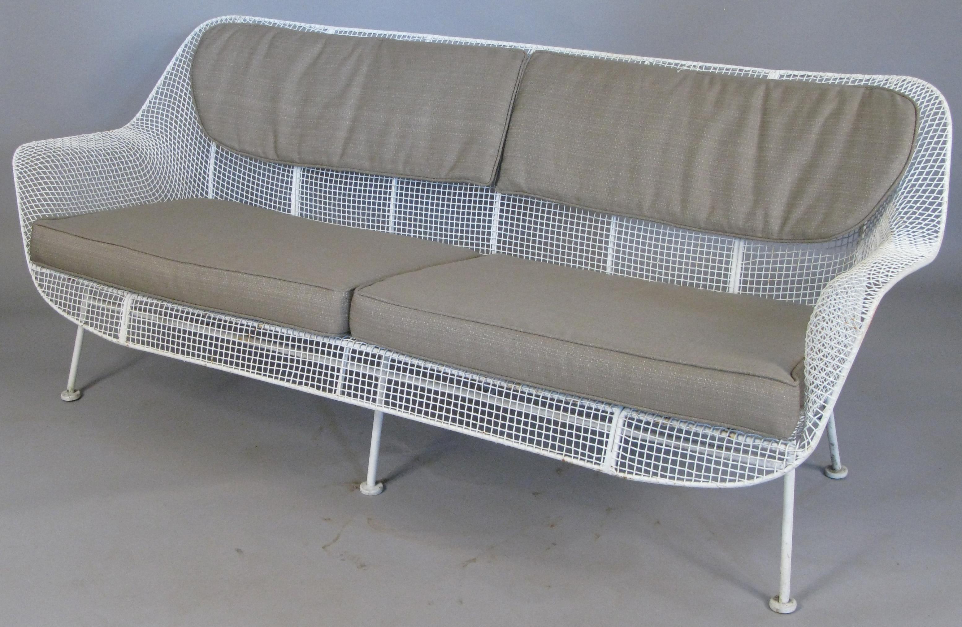 A set of Sculptura lounge seating by Russell Woodard, circa 1950. Set includes a long four seat sofa, and a pair of large lounge chairs with spring bases. Woodard's iconic Sculptura collection is designed with wrought iron frames and woven steel