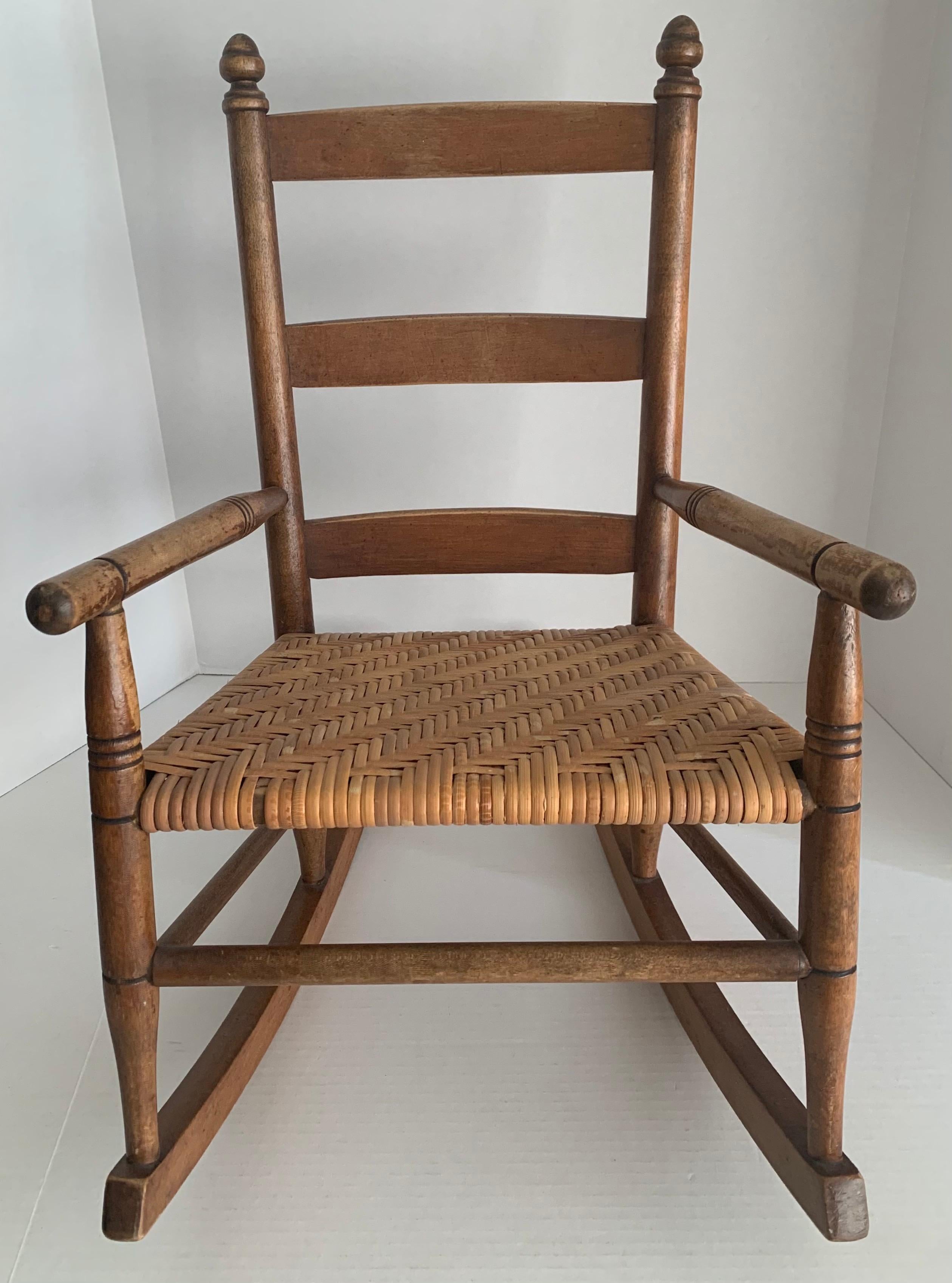 1950s rustic style children’s rocking chair. Original caned seat. Chair is structurally sound. Seat is 13.5” width x 11” deep.
 