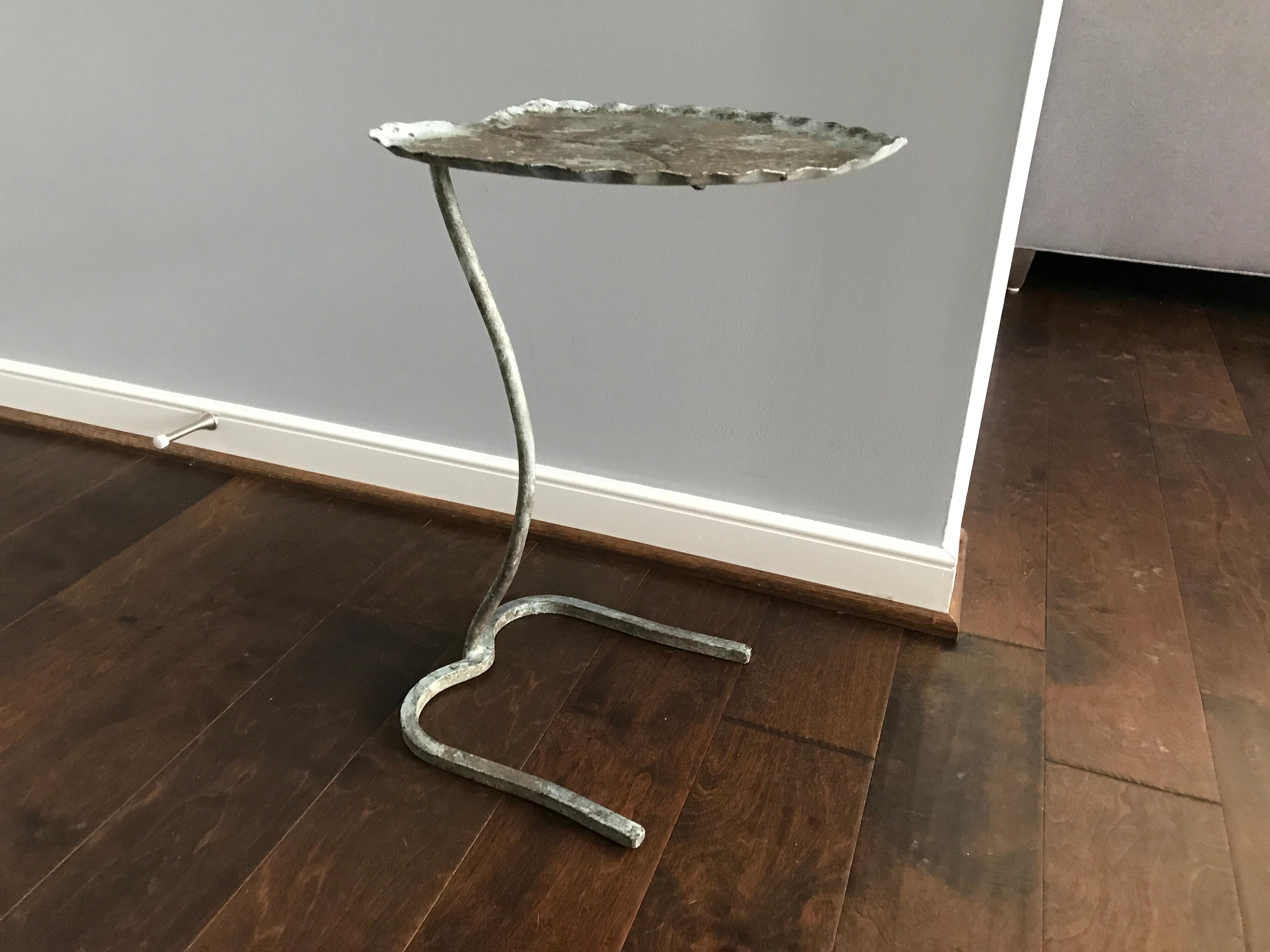 Listed is a stunning, 1950s lily pad sculptural iron side table by John Salterini. The piece has a stunning, all-over verde gris finish that's original to the piece. It looks as if it's never been used and has never been used outdoors.

